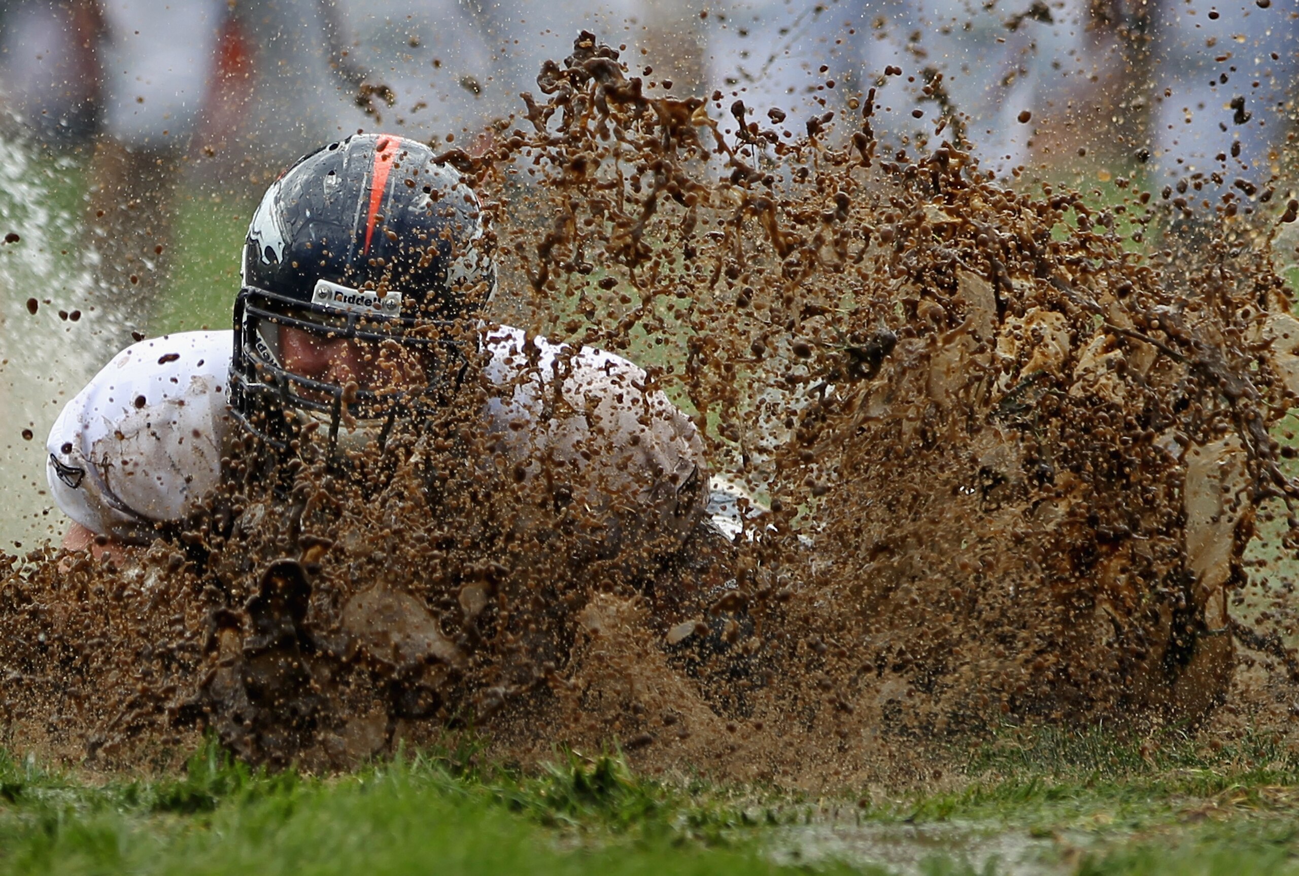 ENGLEWOOD, CO - AUGUST 05:  Zane Beadles #68 of the Denver Broncos dives into the mud as rookies partake in the slip and slide fumble drill during training camp at Dove Valley on August 5, 2010 in Englewood, Colorado.  (Photo by Doug Pensinger/Getty Image
