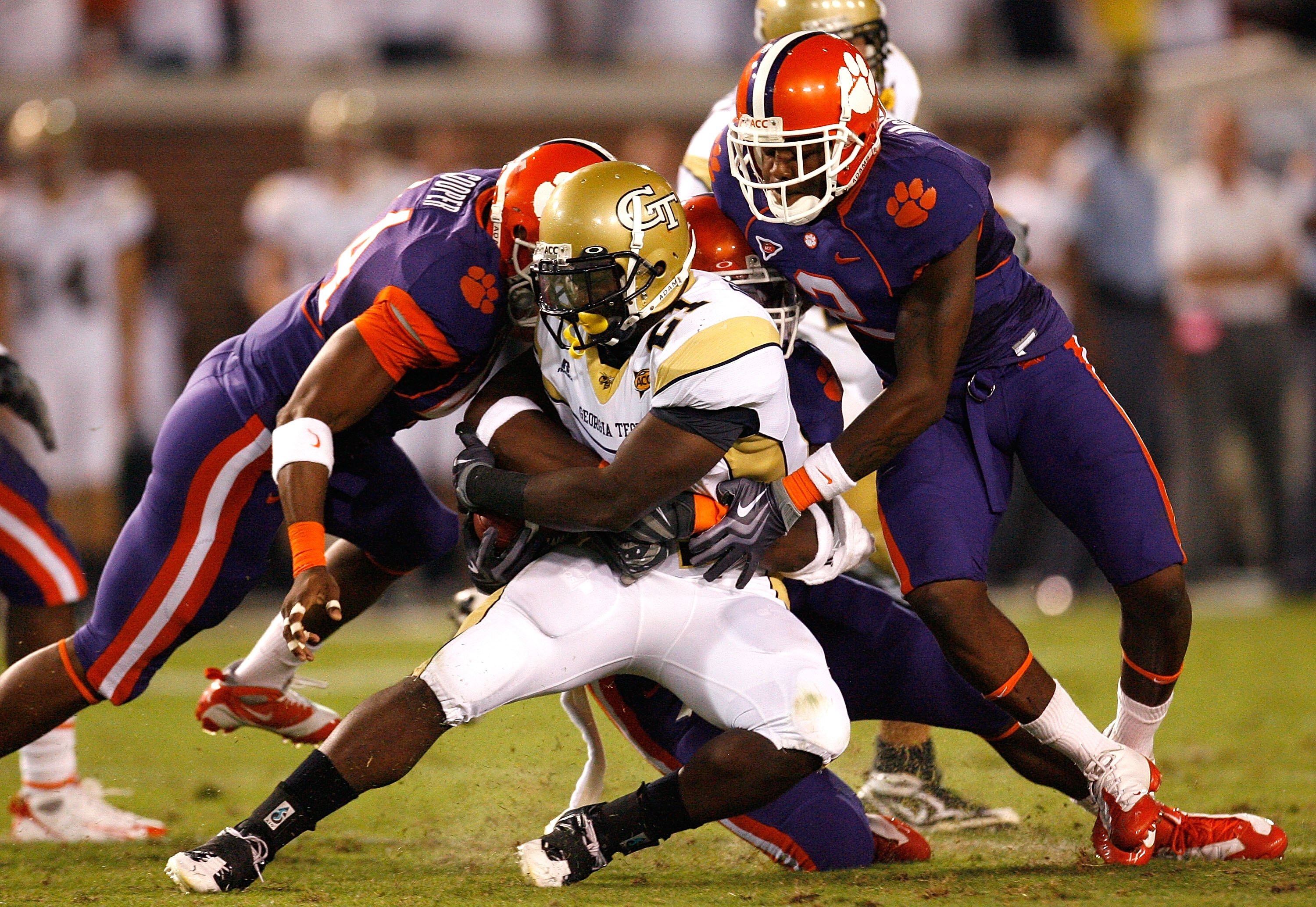 ATLANTA - SEPTEMBER 10:  Running back Jonathan Dwyer #21 of the Georgia Tech Yellow Jackets rushes upfield against Scotty Cooper #44, Andre Branch #40 and DeAndre McDaniel #2 of the Clemson Tigers at Bobby Dodd Stadium on September 10, 2009 in Atlanta, Ge