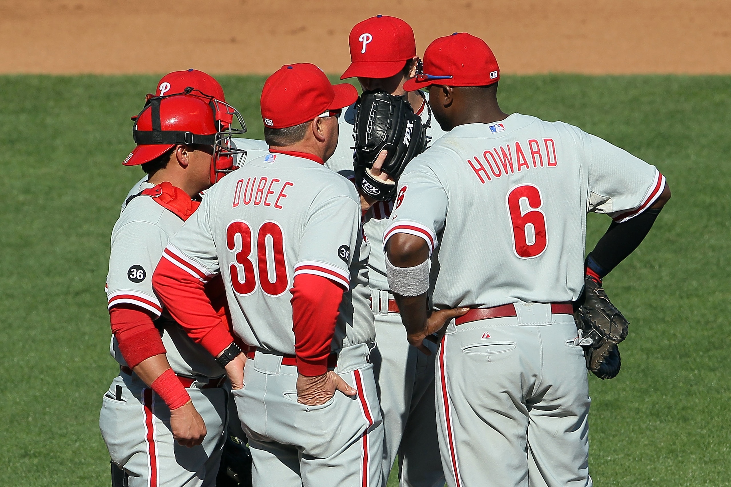 SAN FRANCISCO - OCTOBER 19:  Pitching coach Rich Dubee #30 of the Philadelphia Phillies speaks with Cole Hamels #35 (2nd from R) on the mound during the fourth inning against the San Francisco Giants in Game Three of the NLCS during the 2010 MLB Playoffs