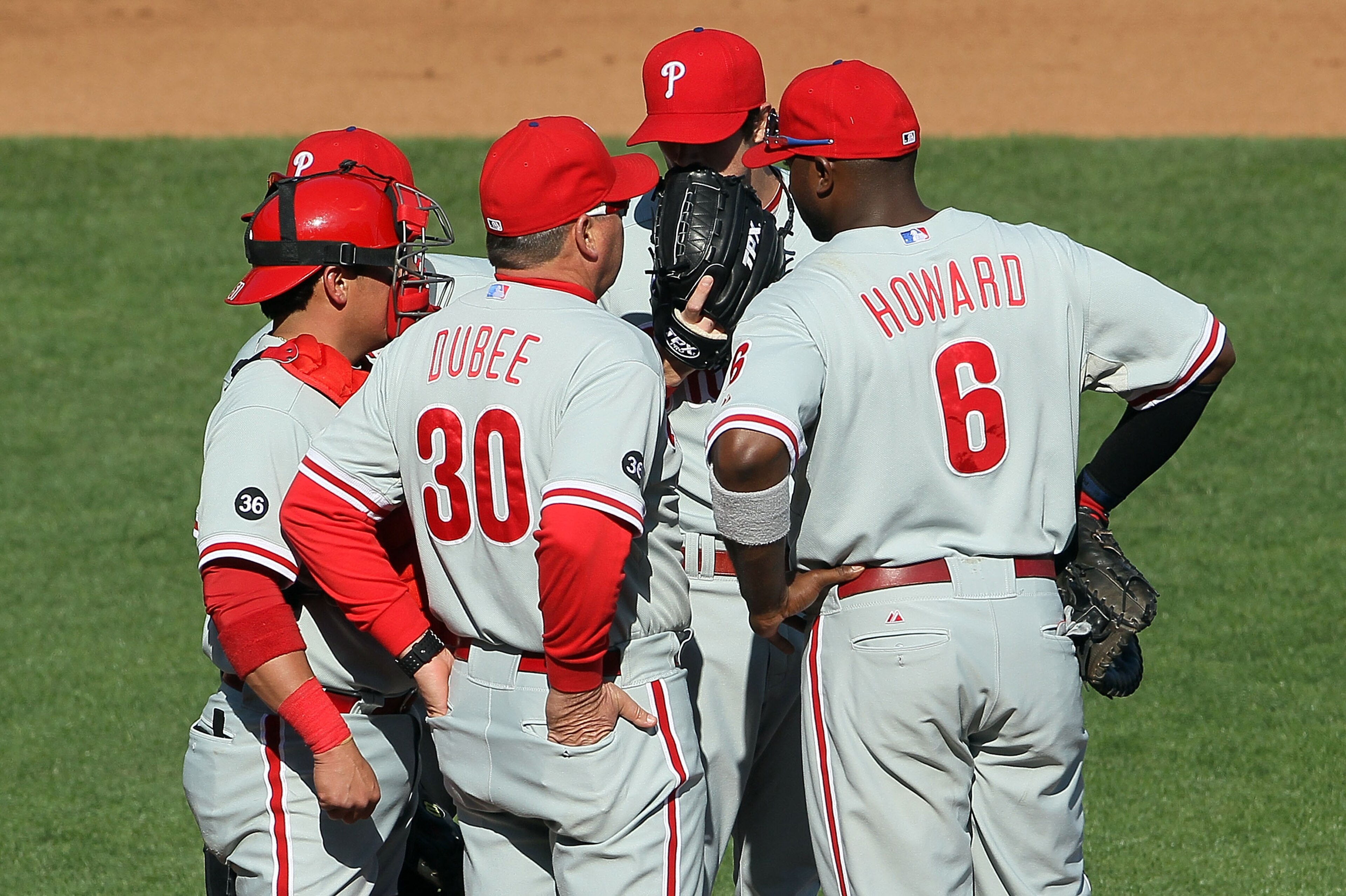 SAN FRANCISCO - OCTOBER 19:  Pitching coach Rich Dubee #30 of the Philadelphia Phillies speaks with Cole Hamels #35 (2nd from R) on the mound during the fourth inning against the San Francisco Giants in Game Three of the NLCS during the 2010 MLB Playoffs