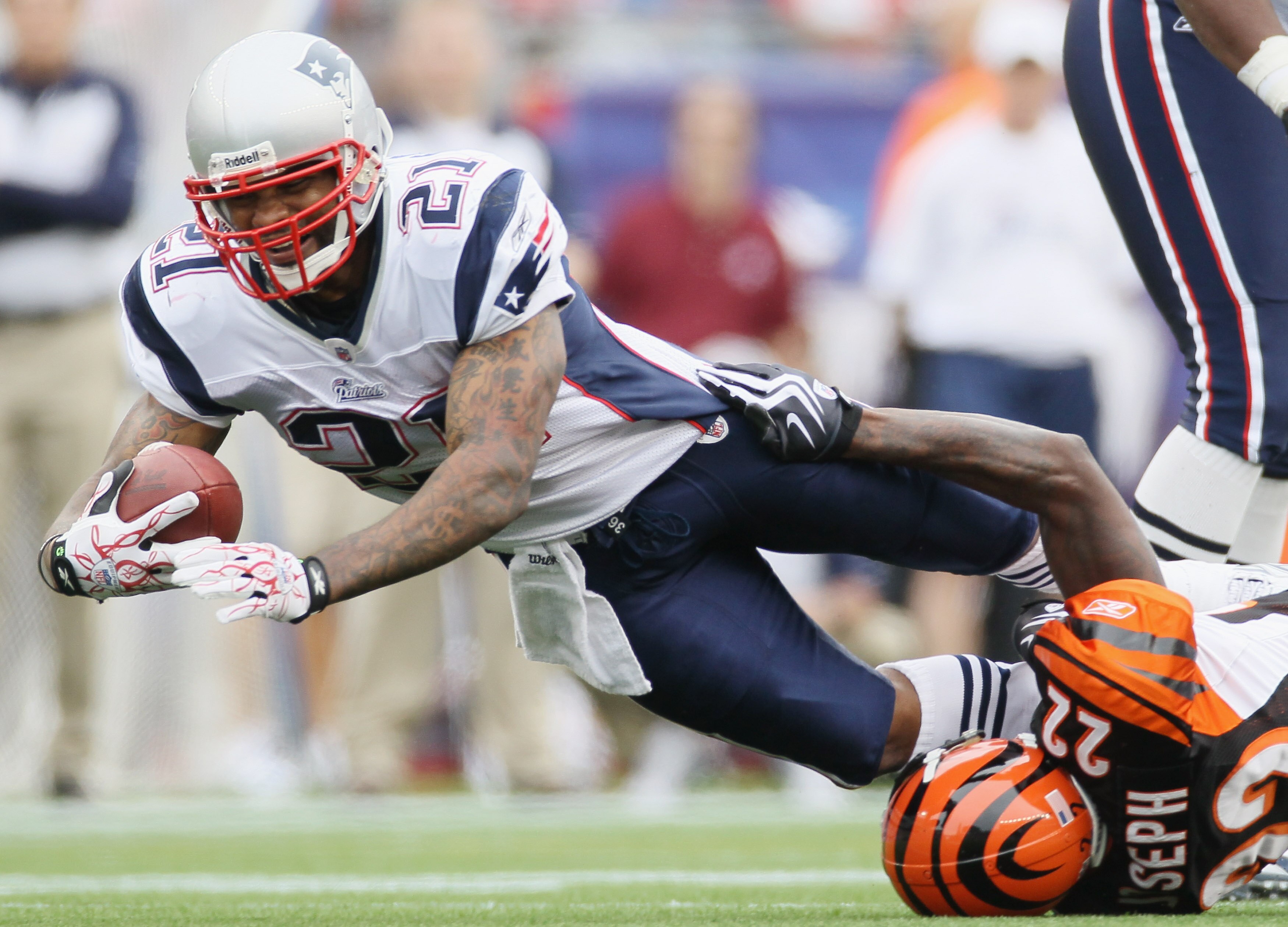 FOXBORO, MA - SEPTEMBER 12:  Fred Taylor #21 of the New England Patriots is tackled by Johnathan Joseph #22 of the Cincinnati Bengals during the NFL season opener on September 12, 2010 at Gillette Stadium in Foxboro, Massachusetts. The Patriots defeated t