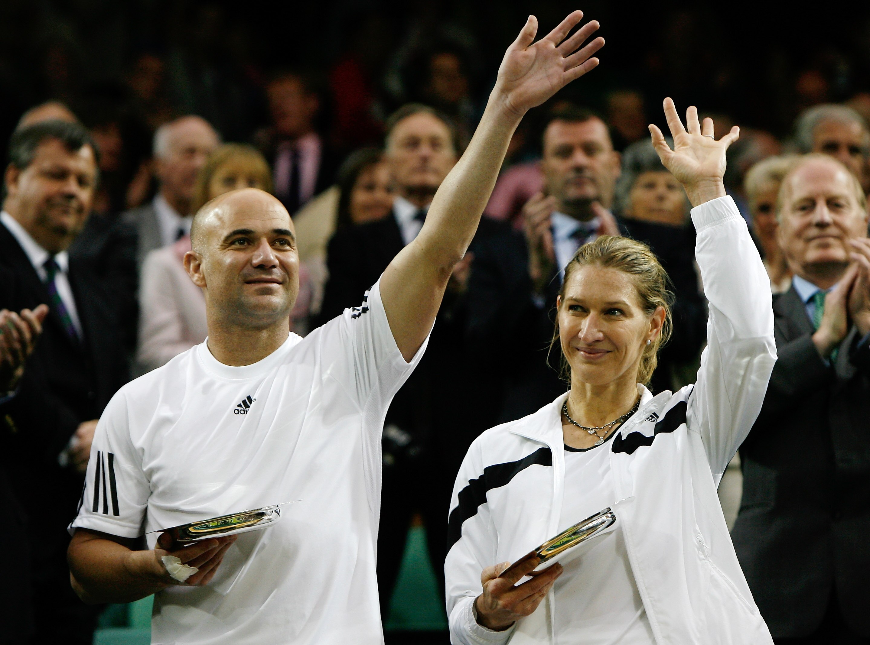 LONDON, ENGLAND - MAY 17:  Andre Agassi and Steffi Graf pose with commemorative trophies following the 'Centre Court Celebration' at Wimbledon on May 17, 2009 in London, England.  (Photo by Paul Gilham/Getty Images)