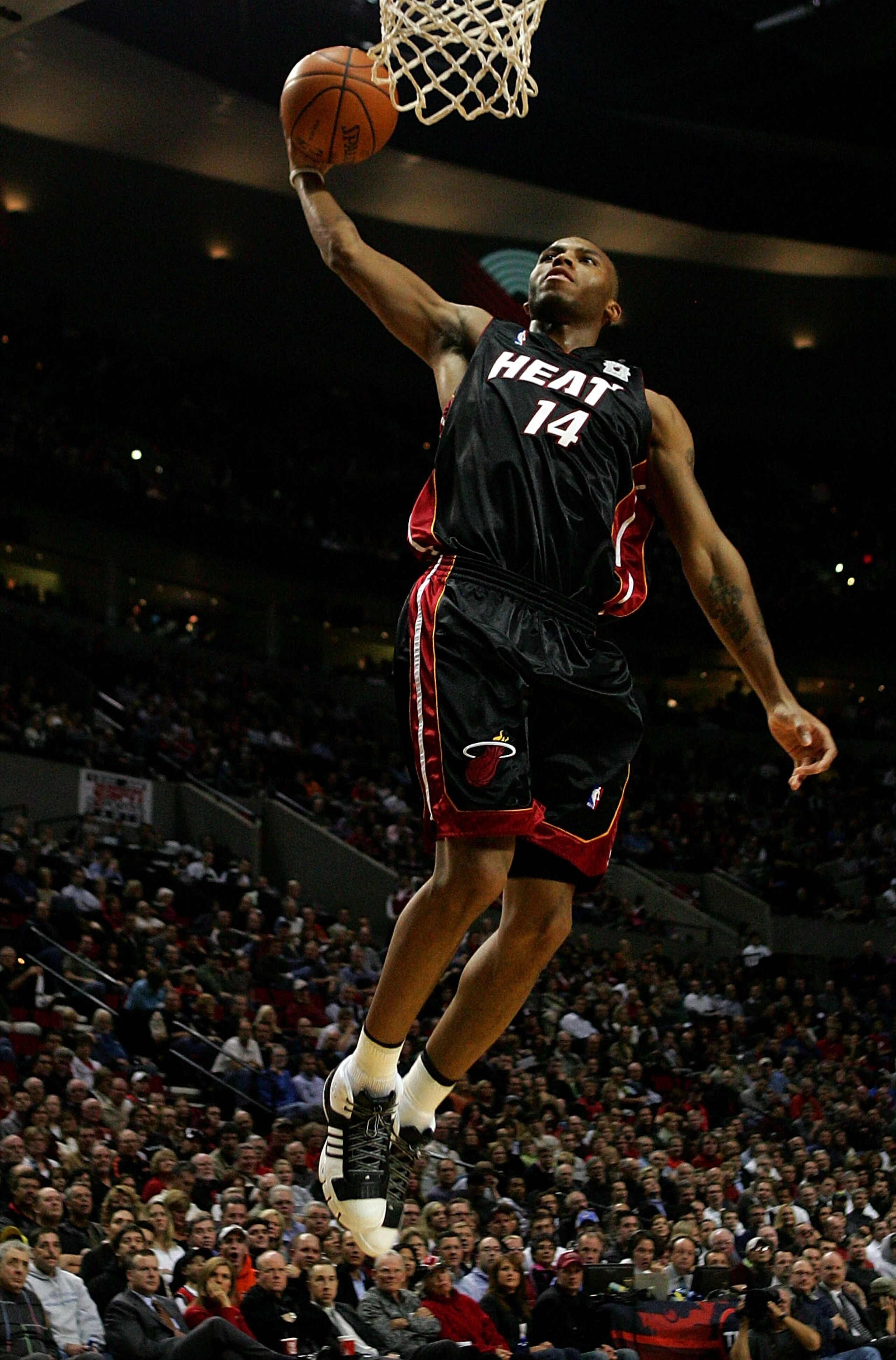 PORTLAND, OR - DECEMBER 6:  Daequan Cook #14 of the Miami Heat  goes up for a dunk against  the Portland Trail Blazers at the Rose Garden December 6, 2007 in Portland, Oregon.  NOTE TO USER: User expressly acknowledges and agrees that, by downloading and