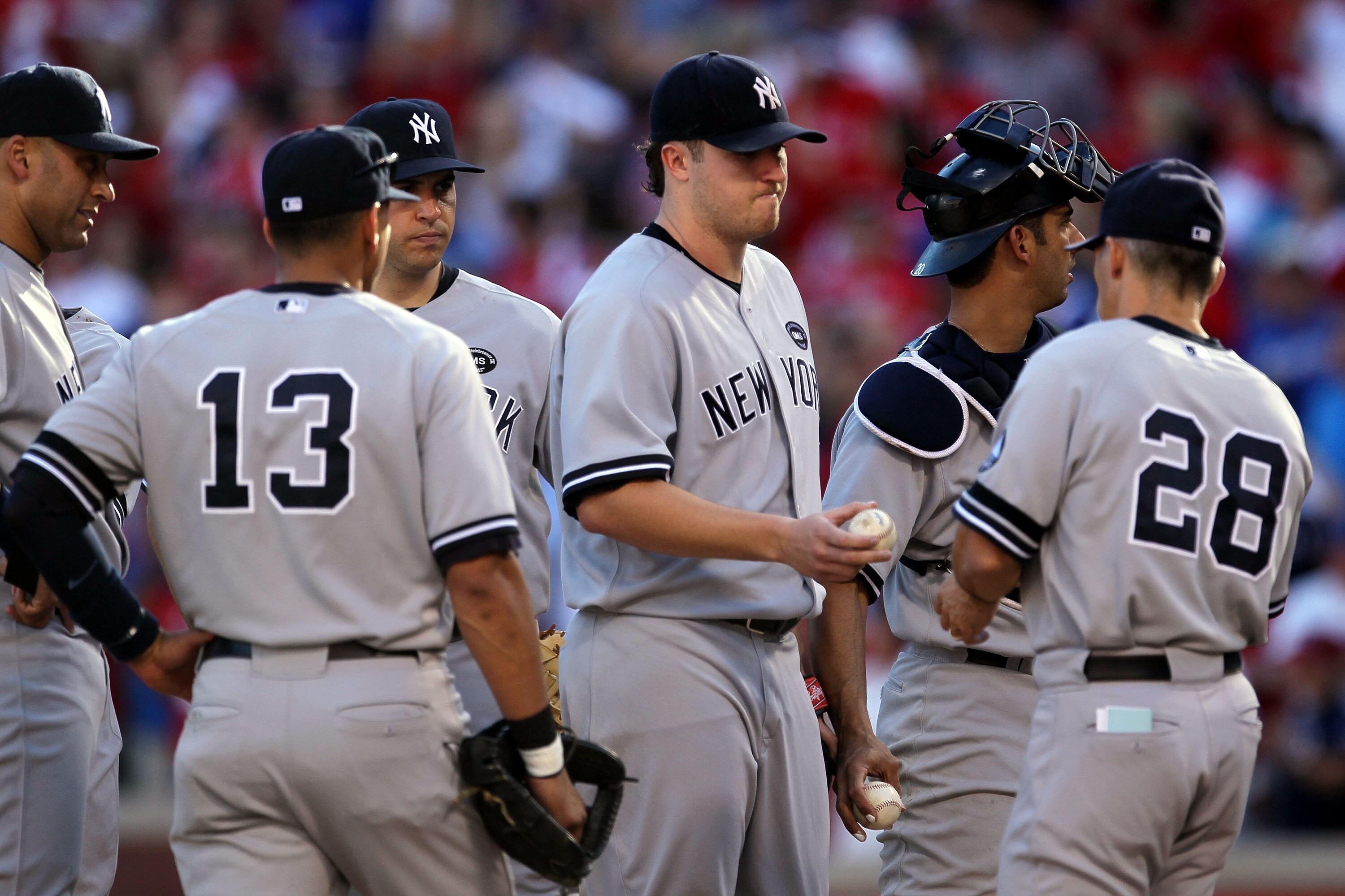 ARLINGTON, TX - OCTOBER 16:  Starting pitcher Phil Hughes #65 of the New York Yankees is taken out of the game in the bottom of the fifth inning by Manager Joe Girardi #28 against the Texas Rangers in Game Two of the ALCS during the 2010 MLB Playoffs at R