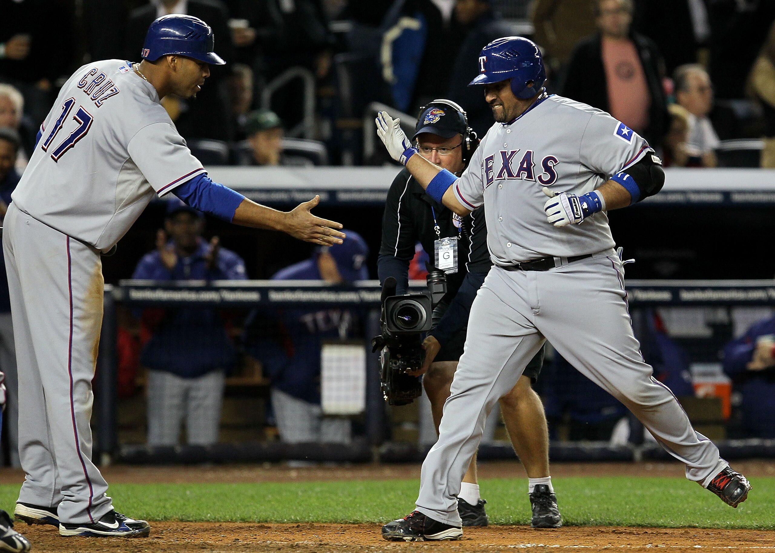 NEW YORK - OCTOBER 19:  Bengie Molina #11 of the Texas Rangers celebrates with Nelson Cruz #17 after hitting a three-run home run in the top of the sixth inning against A.J. Burnett #34 of the New York Yankees  in Game Four of the ALCS during the 2010 MLB