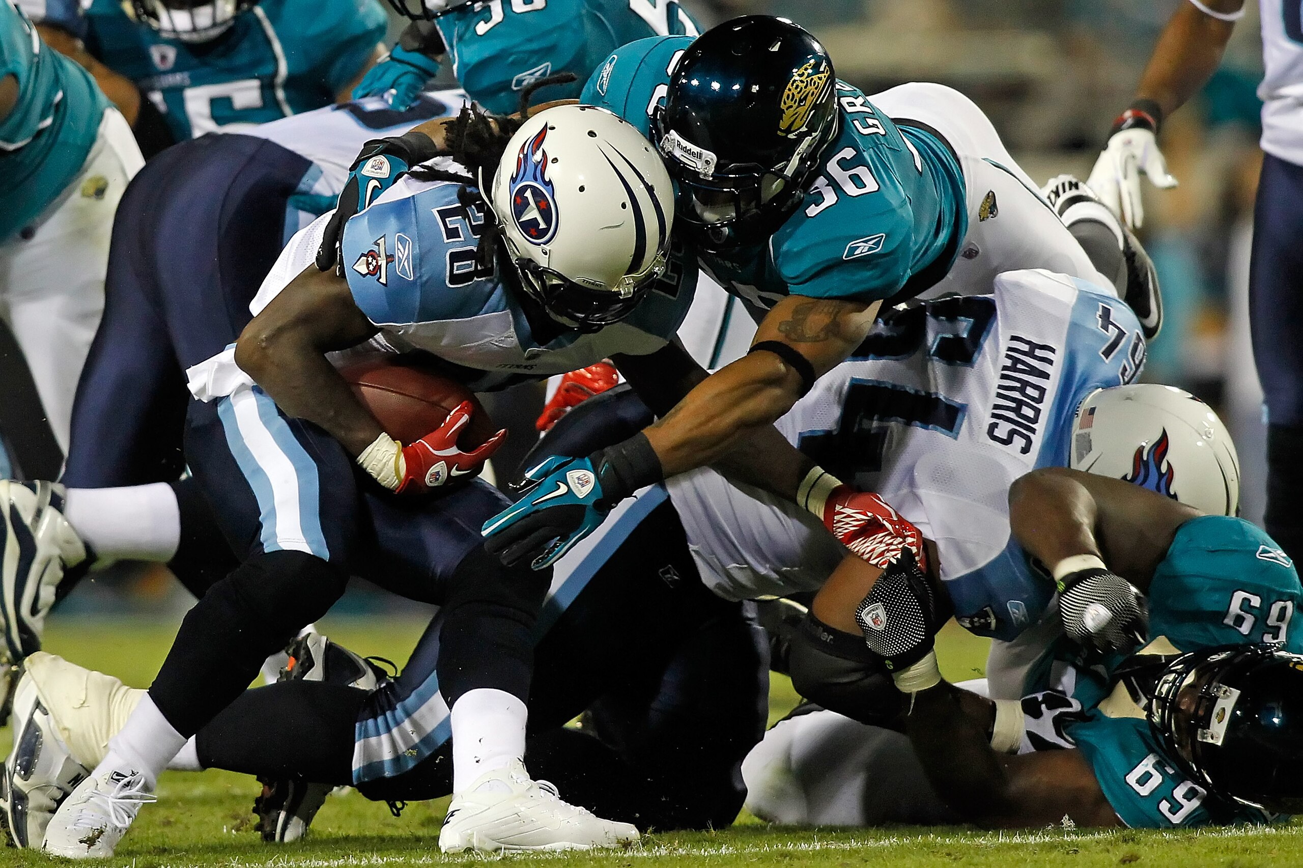 JACKSONVILLE, FL - OCTOBER 18:  Running back Chris Johnson #28 of the Tennessee Titans is tackled by safety Courtney Greene #36 of the Jacksonville Jaguars during the game at EverBank Field on October 18, 2010 in Jacksonville, Florida.  (Photo by J. Meric