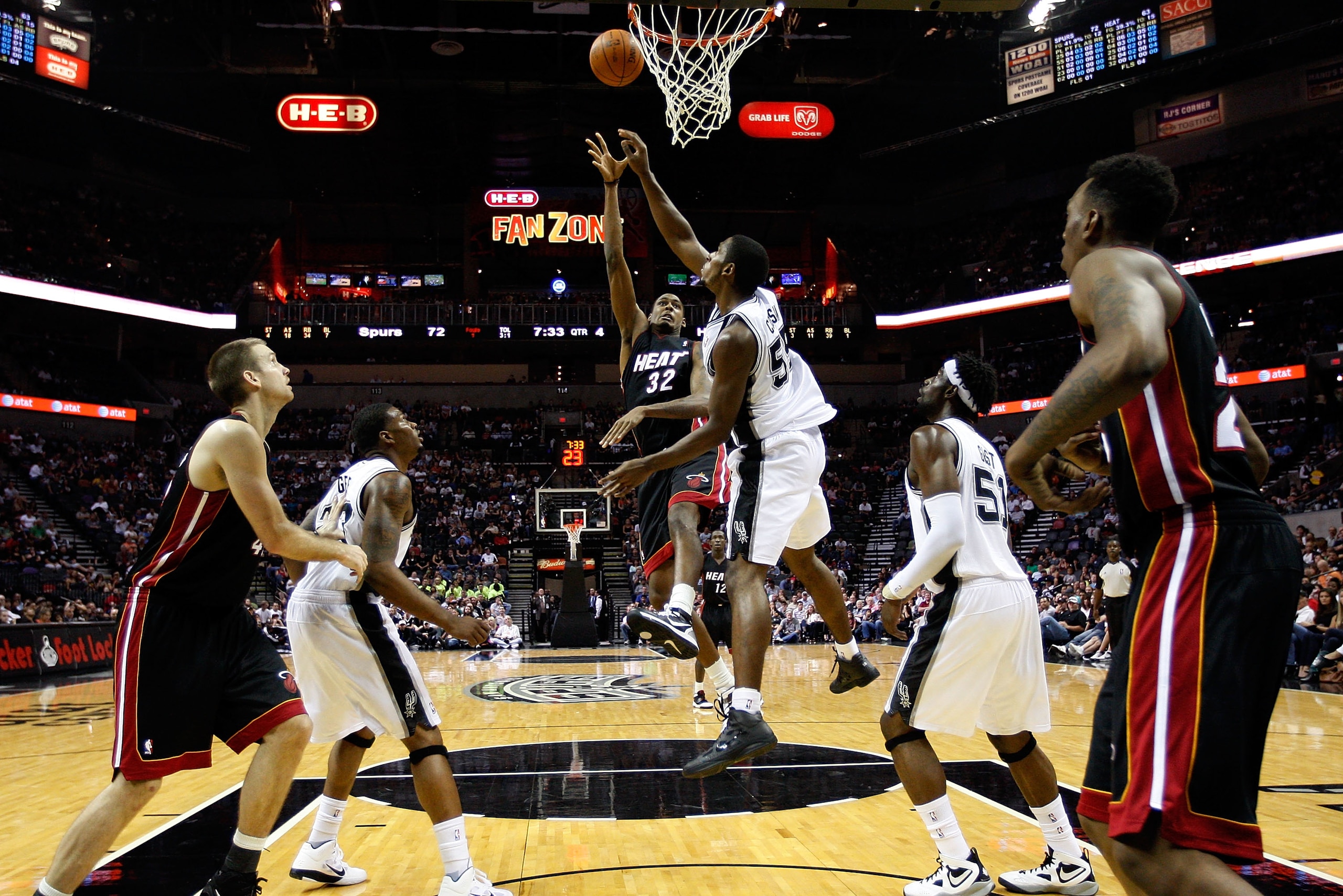 SAN ANTONIO - OCTOBER 09:  Mickell Gladness #32 of the Miami Heat makes a shot over Marcus Cousin #55 of the San Antonio Spurs at the AT&T Center on October 9, 2010 in San Antonio, Texas.  NOTE TO USER: User expressly acknowledges and agrees that, by down