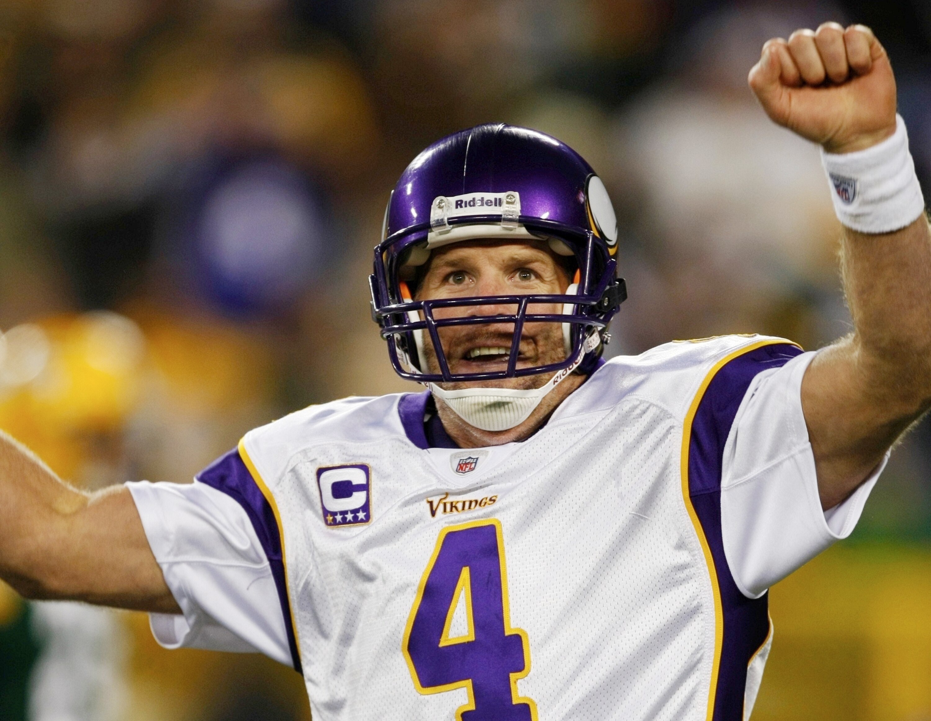 GREEN BAY, WI - NOVEMBER 01: Quarterback Brett Favre #4 of the Minnesota Vikings celebrates a touchdown by teammate Percy Harvin #12 after a 51 yard touchdown pass during the third quarter of the game against the Green Bay Packers at Lambeau Field on Nove