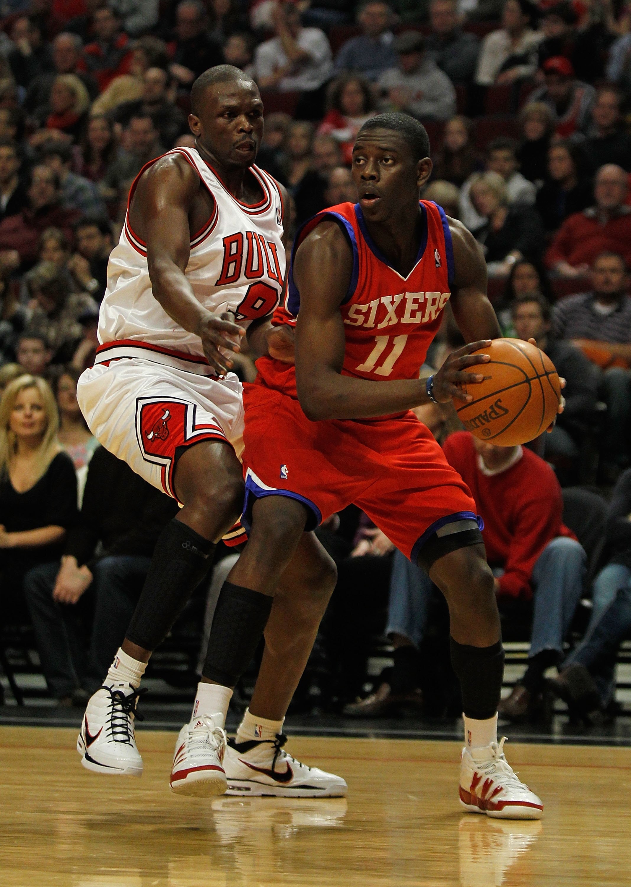 CHICAGO - FEBRUARY 20: Jrue Holiday #11 of the Philadelphia 76ers looks to pass under pressure from Loul Deng #9 of the Chicago Bulls at the United Center on February 20, 2010 in Chicago, Illinois. The Bulls defeated the 76ers 122-90. NOTE TO USER: User e
