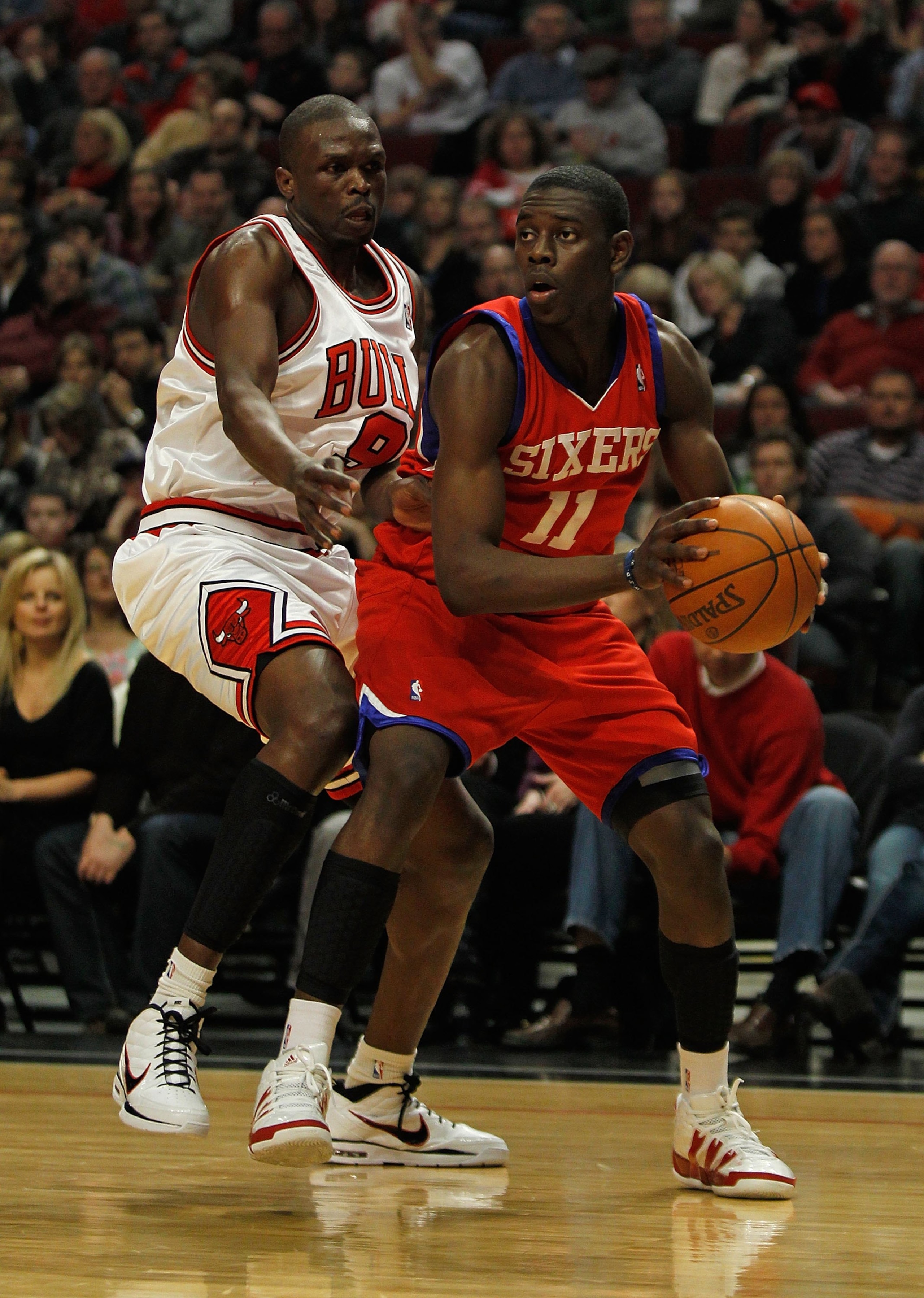 CHICAGO - FEBRUARY 20: Jrue Holiday #11 of the Philadelphia 76ers looks to pass under pressure from Loul Deng #9 of the Chicago Bulls at the United Center on February 20, 2010 in Chicago, Illinois. The Bulls defeated the 76ers 122-90. NOTE TO USER: User e CHICAGO - FEBRUARY 20: Jrue Holiday #11 of the Philadelphia 76ers looks to pass under pressure from Loul Deng #9 of the Chicago Bulls at the United Center on February 20, 2010 in Chicago, Illinois. The Bulls defeated the 76ers 122-90. NOTE TO USER: User e