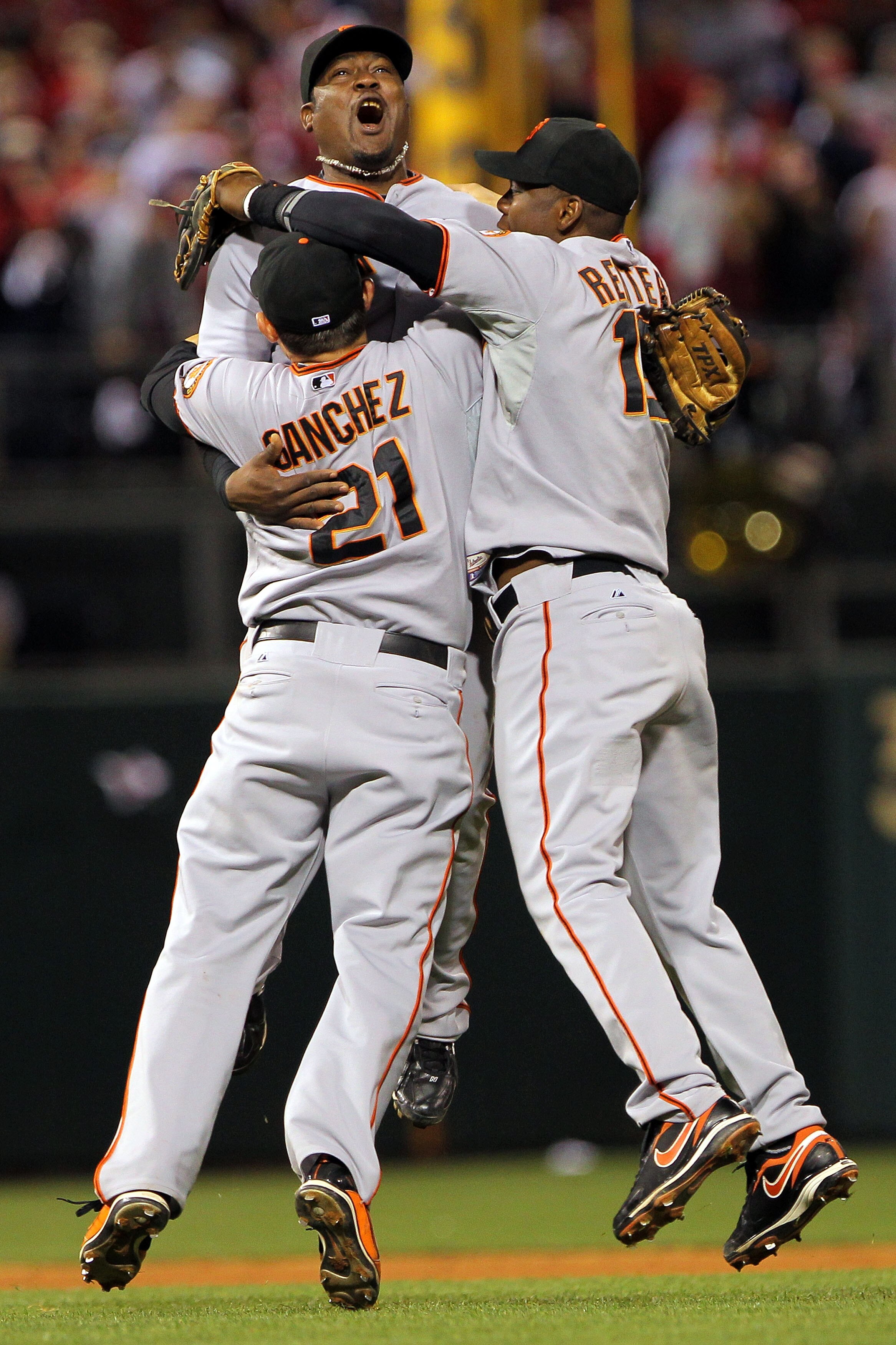 PHILADELPHIA - OCTOBER 23:  Freddy Sanchez #21, Juan Uribe #5 and Edgar Renteria #16 of the San Francisco Giants celebrate defeating the Philadelphia Phillies 3-2 and winning the pennant in Game Six of the NLCS during the 2010 MLB Playoffs at Citizens Ban