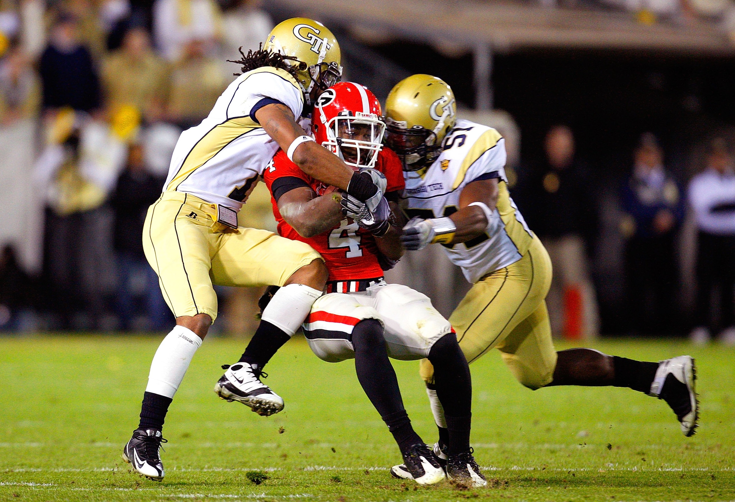 ATLANTA - NOVEMBER 28:  Morgan Burnett #1 and Brad Jefferson #51 of the Georgia Tech Yellow Jackets against Caleb King #4 of the Georgia Bulldogs at Bobby Dodd Stadium on November 28, 2009 in Atlanta, Georgia.  (Photo by Kevin C. Cox/Getty Images)