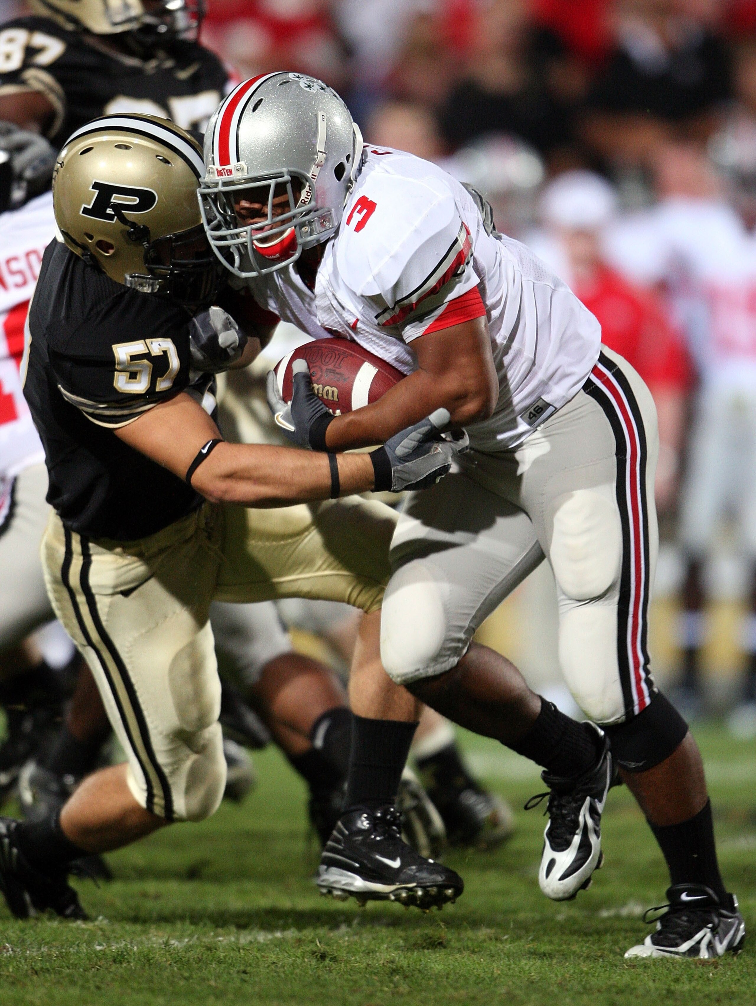 WEST LAFAYETTE, IN - OCTOBER 06:  Brandon Saine #3 of the Ohio State Buckeyes runs with the ball while defended by Tyler Haston #57 the Purdue Boilermakers during the game on October 6, 2007 at Ross-Ade Stadium in West Lafayette, Indiana.  (Photo by Andy 