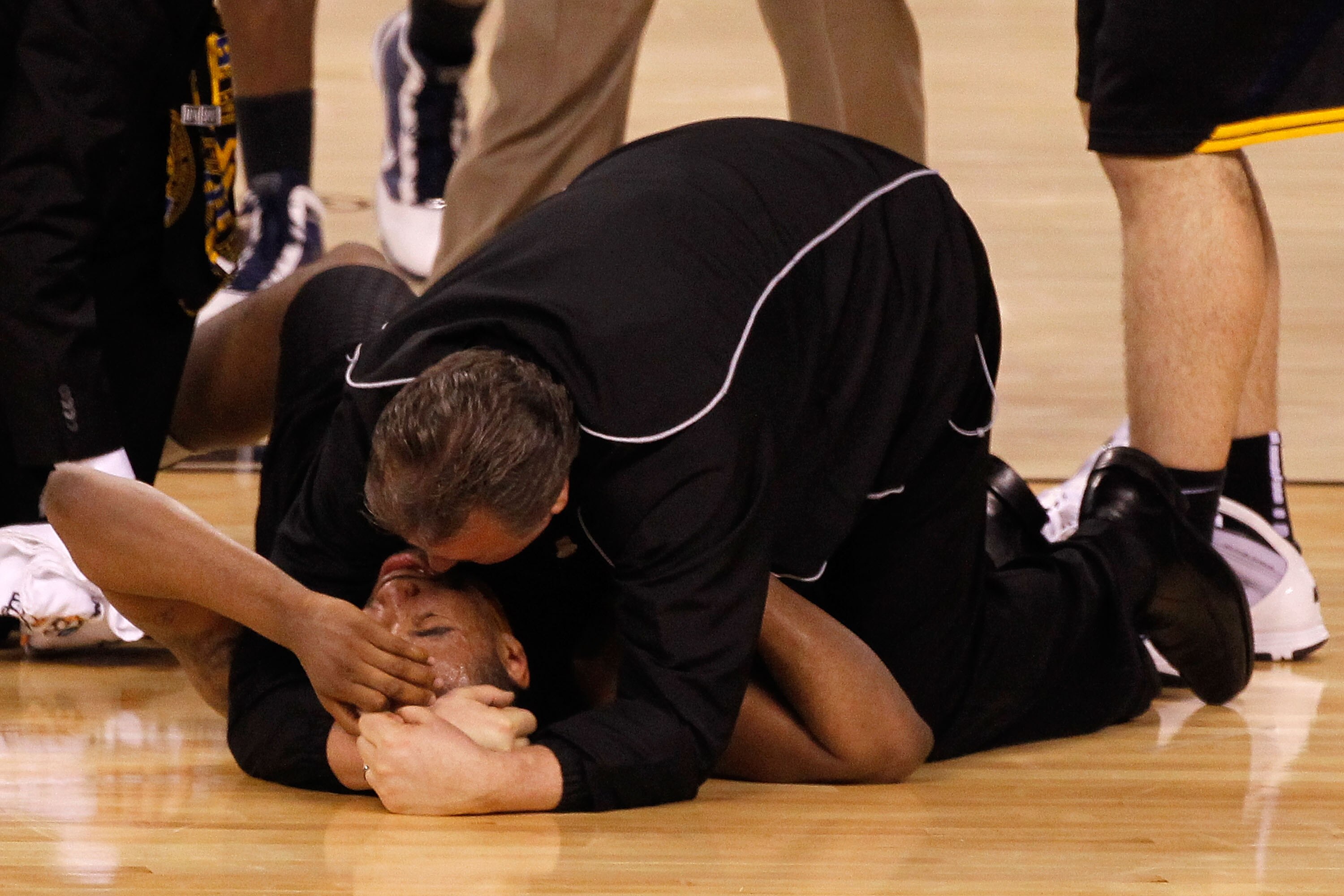 INDIANAPOLIS - APRIL 03:  Head coach Bob Huggins consoles Da'Sean Butler #1 of the West Virginia Mountaineers after Butler injured his knee in the second half against the Duke Blue Devils during the National Semifinal game of the 2010 NCAA Division I Men'