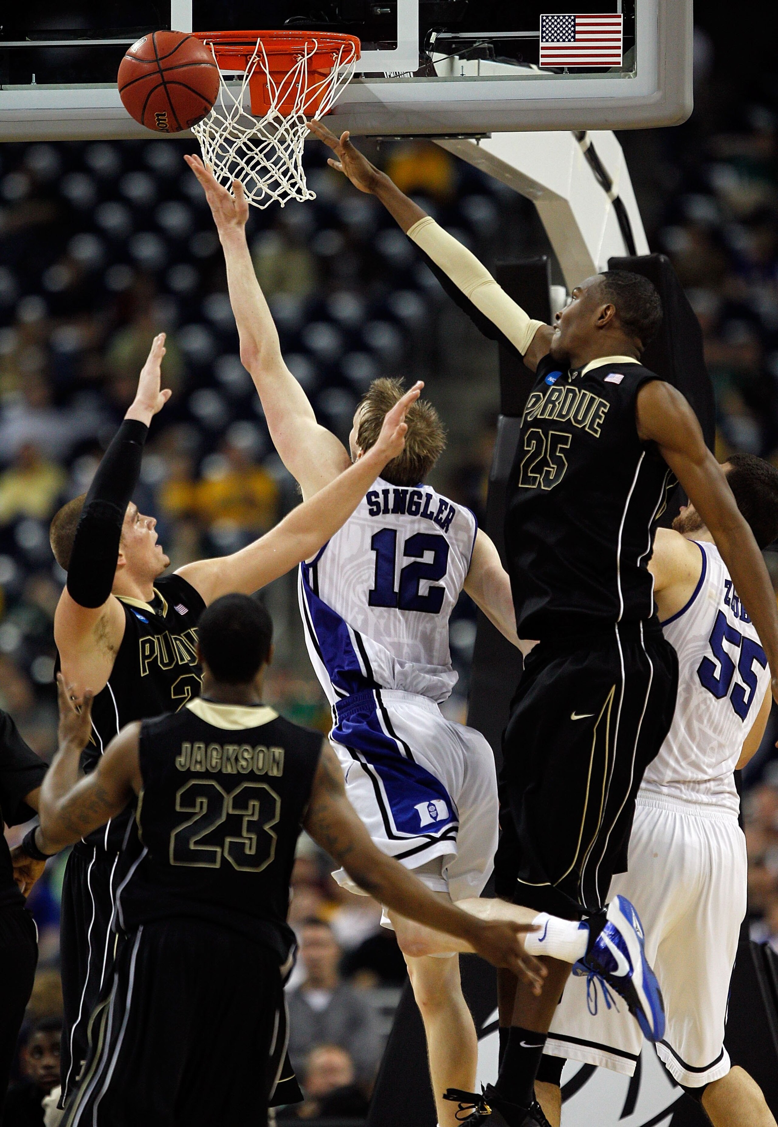 HOUSTON - MARCH 26: Kyle Singler #12 of the Duke Blue Devils puts up a shot against Lewis Jackson #23, D.J. Byrd #21 and JaJuan Johnson #25 of the Purdue Boilermakers during the south regional semifinal of the 2010 NCAA men's basketball tournament at Reli