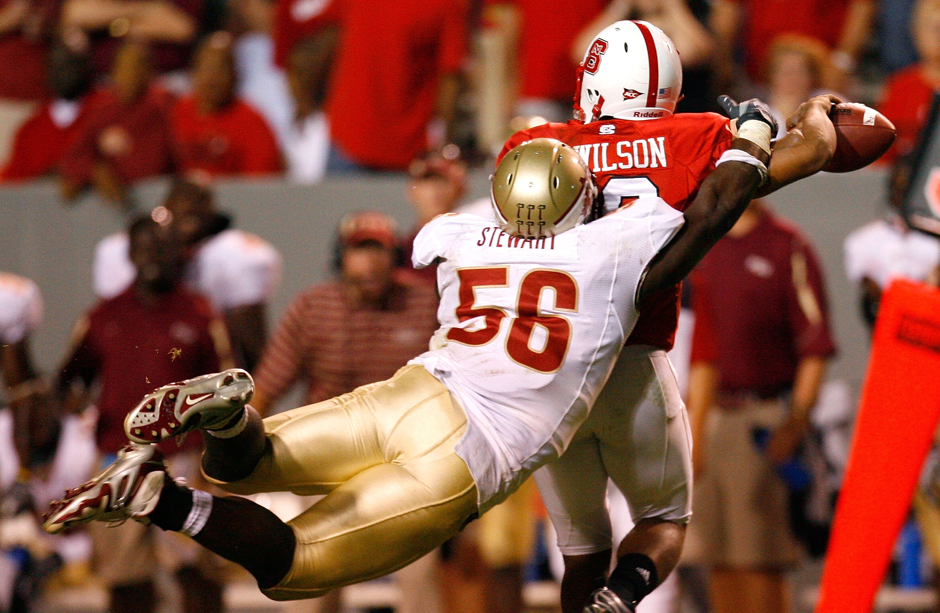 RALEIGH, NC - OCTOBER 16:  Kendrick Stewart #56 of the Florida State Seminoles dives and sacks quarterback Russell Wilson #16 of the North Carolina State Wolfpack during the game at Carter-Finley Stadium on September 16, 2008 in Raleigh, North Carolina.  