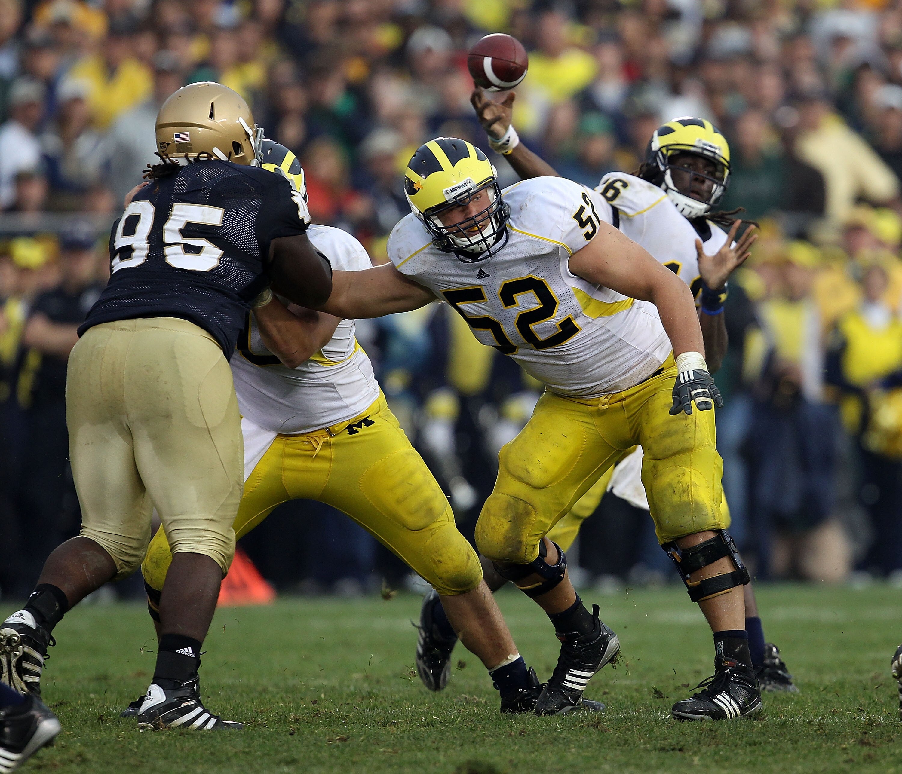 SOUTH BEND, IN - SEPTEMBER 11: Stephen Schilling #52 of the Michigan Wolverines blocks for quarterback Denard Robinson #16 as Ian Williams #95 of the Notre Dame Fighting Irish rushes at Notre Dame Stadium on September 11, 2010 in South Bend, Indiana. Mich