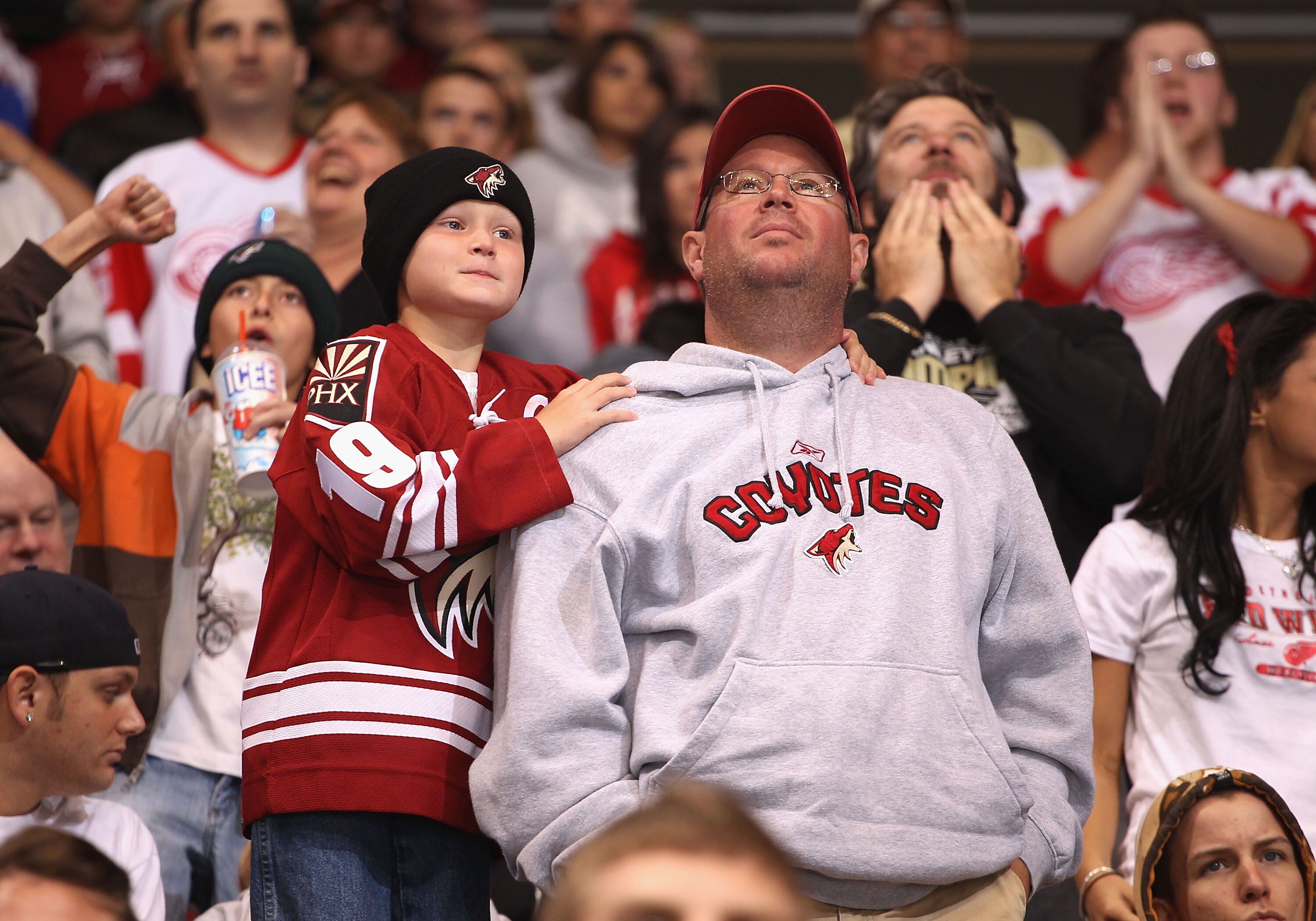 GLENDALE, AZ - OCTOBER 16:  Fans of the Phoenix Coyotes cheer during the NHL game against the Detroit Red Wings at Jobing.com Arena on October16, 2010 in Glendale, Arizona.  The Red Wings defeated the Coyotes 2-1 in overtime.  (Photo by Christian Petersen