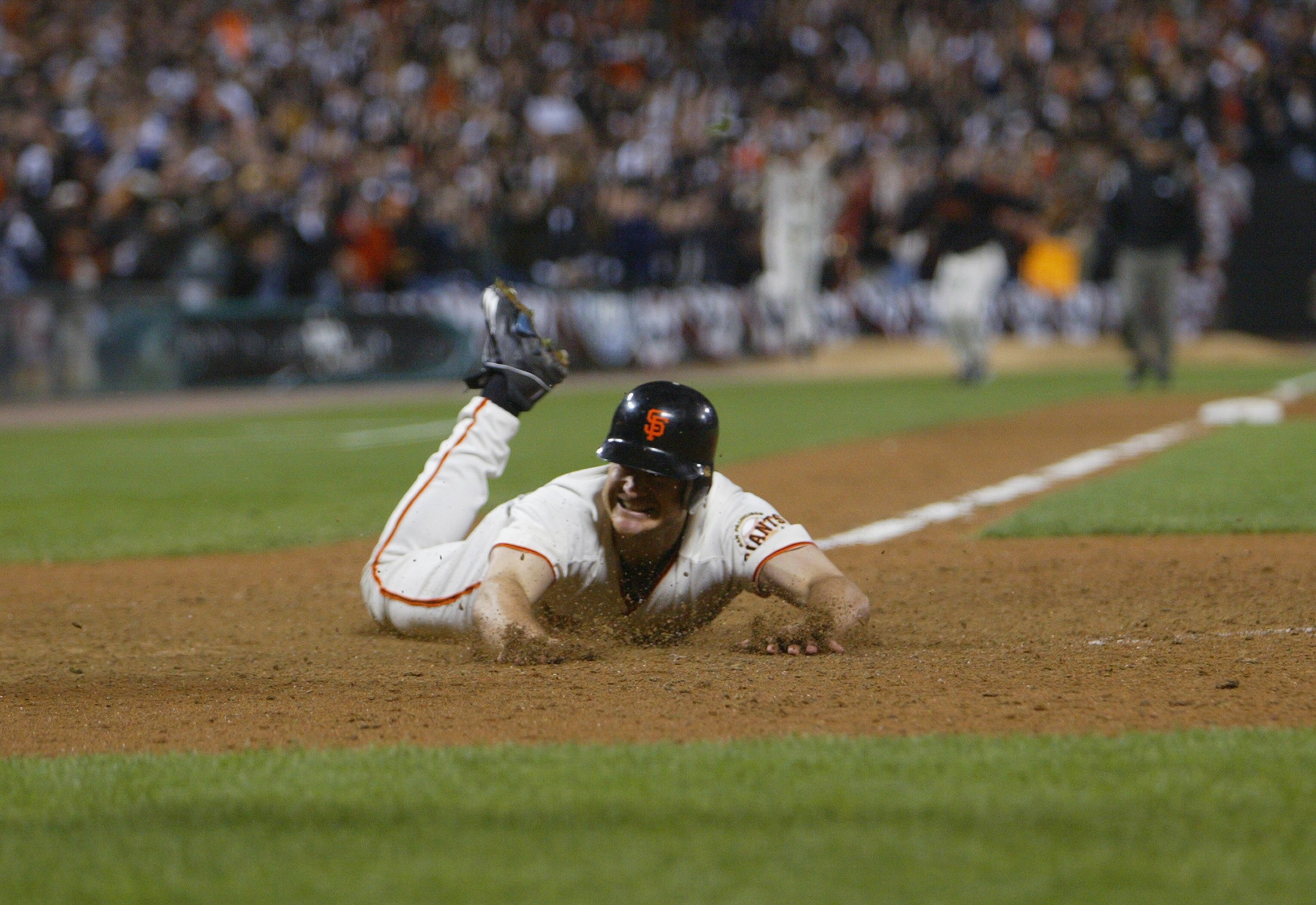 SAN FRANCISCO - OCTOBER 14:  Third baseman David Bell #28 of the San Francisco Giants slides into home plate with the game-winning run to end game five of the National League Championship Series against the St. Louis Cardinals on October 14, 2002 at Pacif
