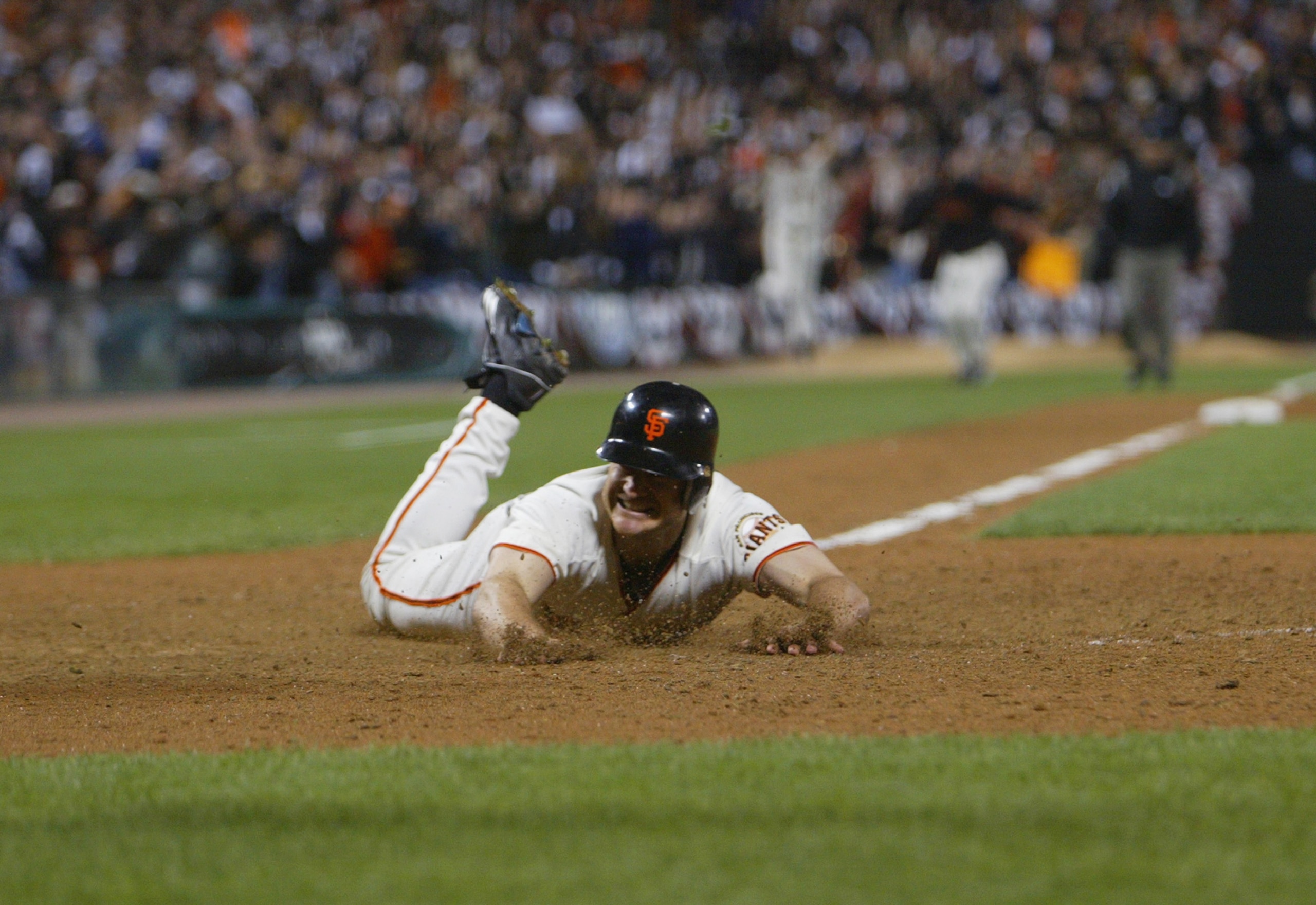 SAN FRANCISCO - OCTOBER 14:  Third baseman David Bell #28 of the San Francisco Giants slides into home plate with the game-winning run to end game five of the National League Championship Series against the St. Louis Cardinals on October 14, 2002 at Pacif