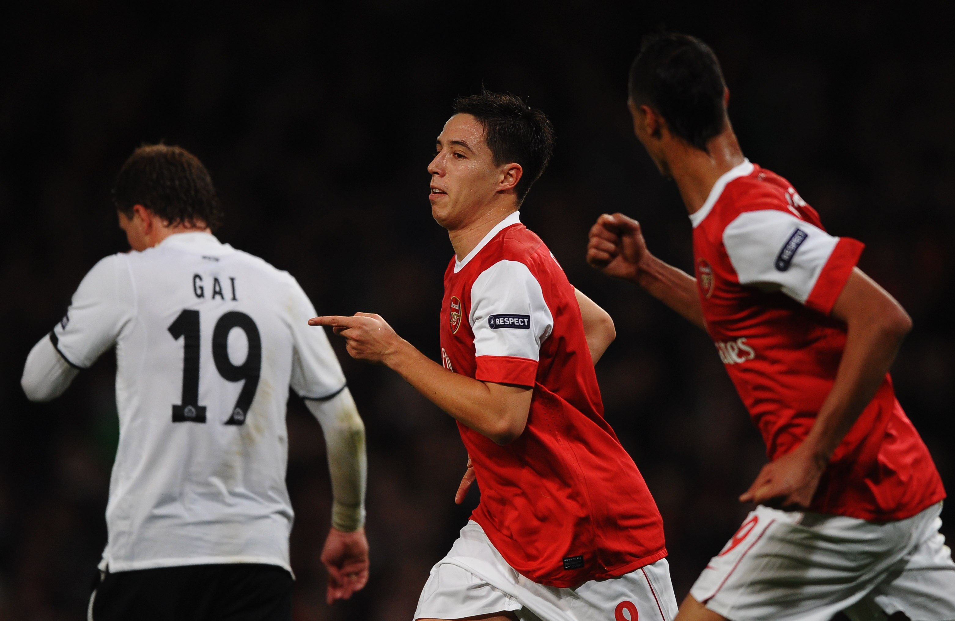 LONDON, ENGLAND - OCTOBER 19:  Samir Nasri of Arsenal (C) celebrates with team mate Marouane Chamakh (R) as he scores their second goal during the UEFA Champions League Group H match between Arsenal and FC Shakhtar Donetsk at the Emirates Stadium on Octob