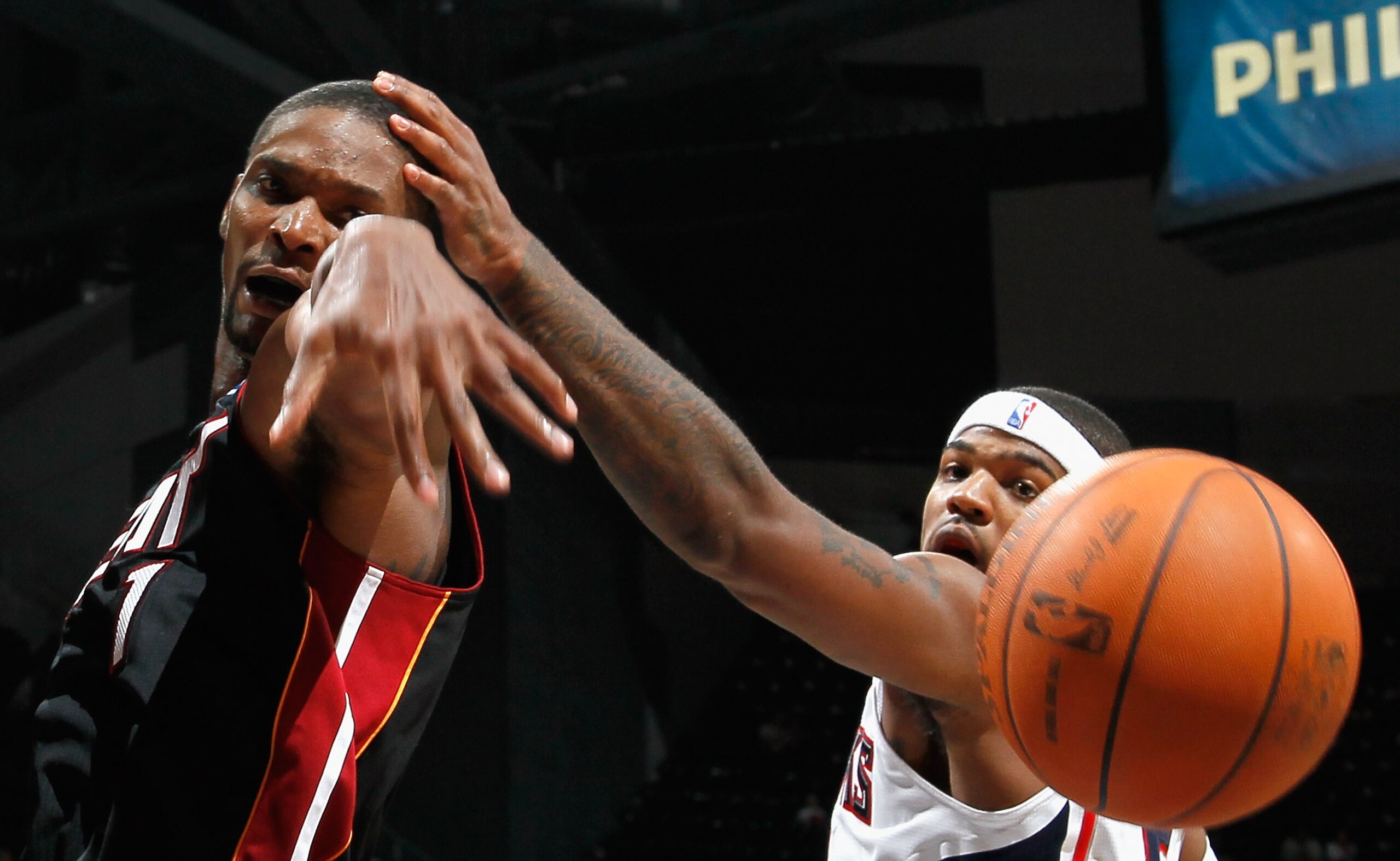 ATLANTA - OCTOBER 21:  Josh Smith #5 of the Atlanta Hawks grabs the head of Chris Bosh #1 of the Miami Heat while battling for a rebound at Philips Arena on October 21, 2010 in Atlanta, Georgia.  (Photo by Kevin C. Cox/Getty Images)