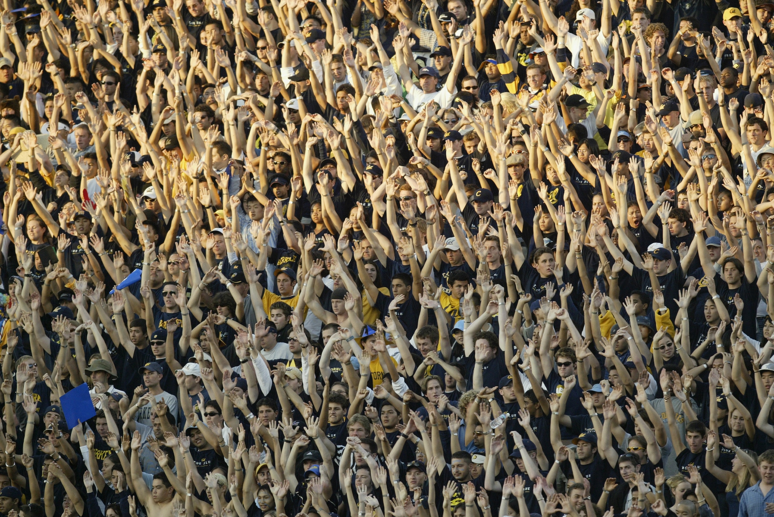 BERKELEY, CA  - SEPTEMBER 27:  Fans of the California Golden Bears cheer during the game against the USC Trojans at Memorial Stadium on September 27, 2003 in Berkeley, California.  Cal won 34-31 in triple overtime.  (Photo by Stephen Dunn/Getty Images)
