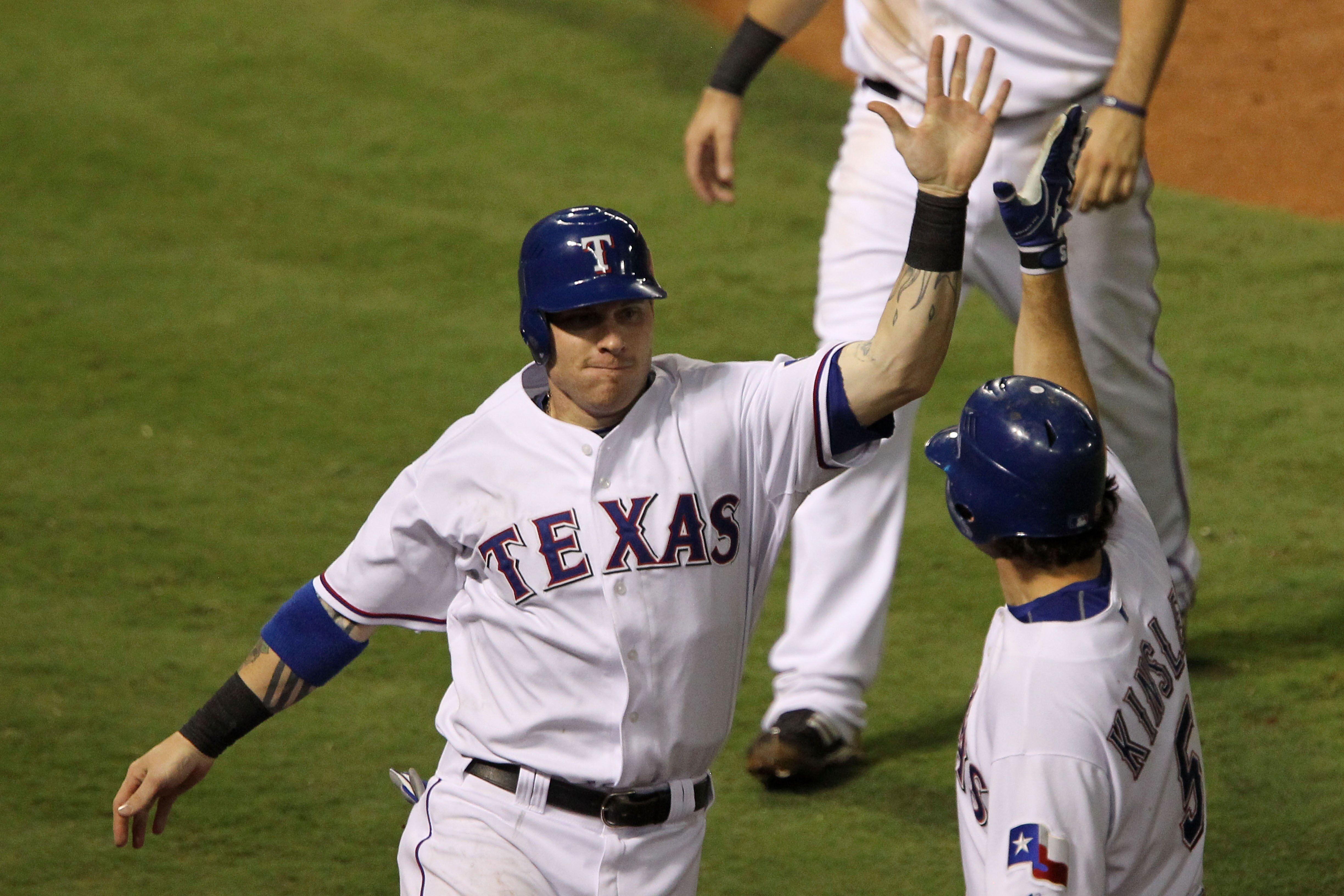 ARLINGTON, TX - OCTOBER 22:  Josh Hamilton #32 of the Texas Rangers celebrates with Ian Kinsler #5 after scoring on a double by Vladimir Guerrero #27 in the fifth inning of Game Six of the ALCS against the New York Yankees during the 2010 MLB Playoffs at