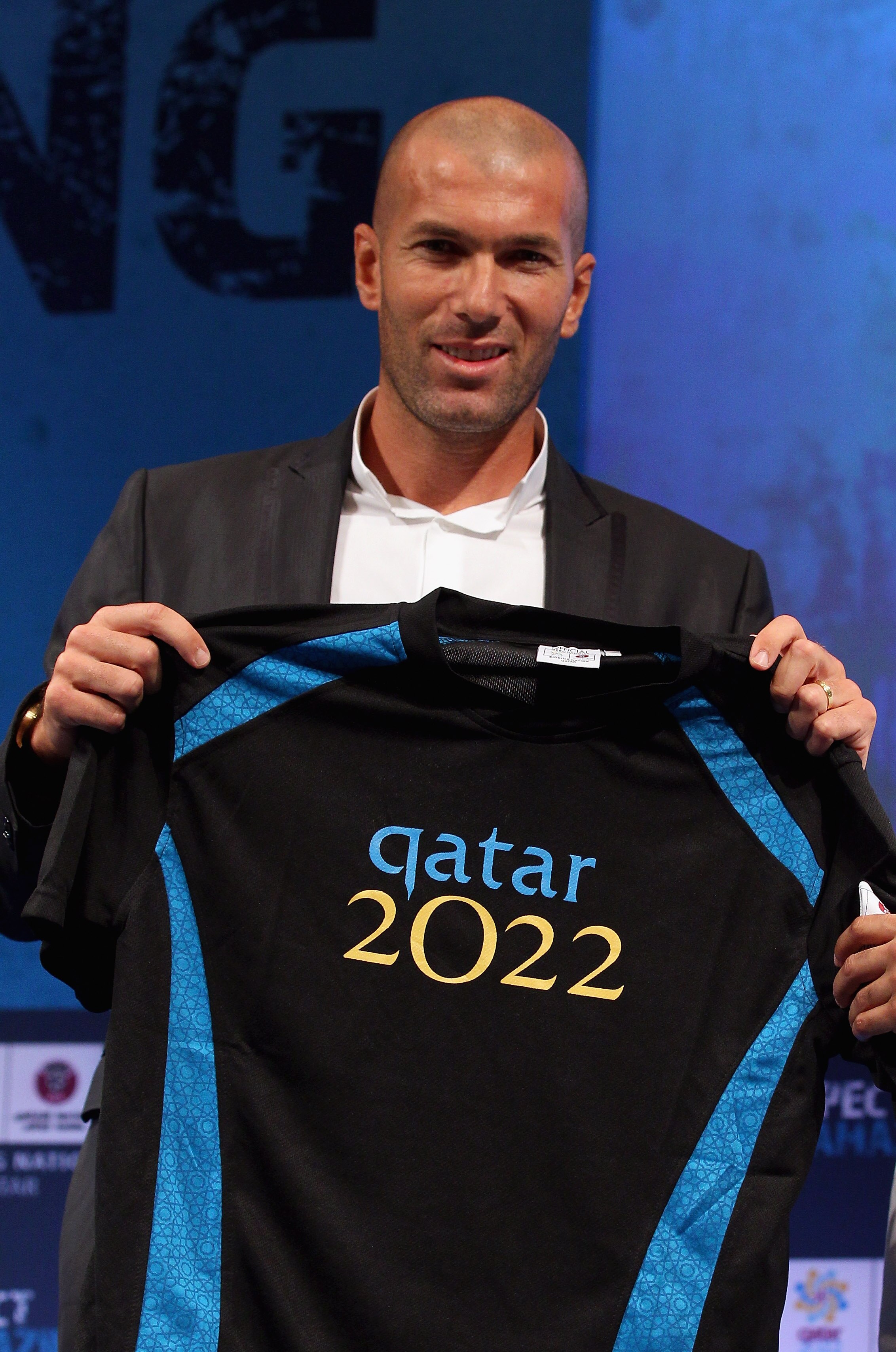DOHA, QATAR - SEPTEMBER 16:  Qatar 2022 World Cup bid new official Ambassador Zinedine Zidane poses with his personalised shirt at the Four Seasons hotel on September 16, 2010 in Doha, Qatar.  (Photo by Clive Rose/Getty Images for Qatar 2022)