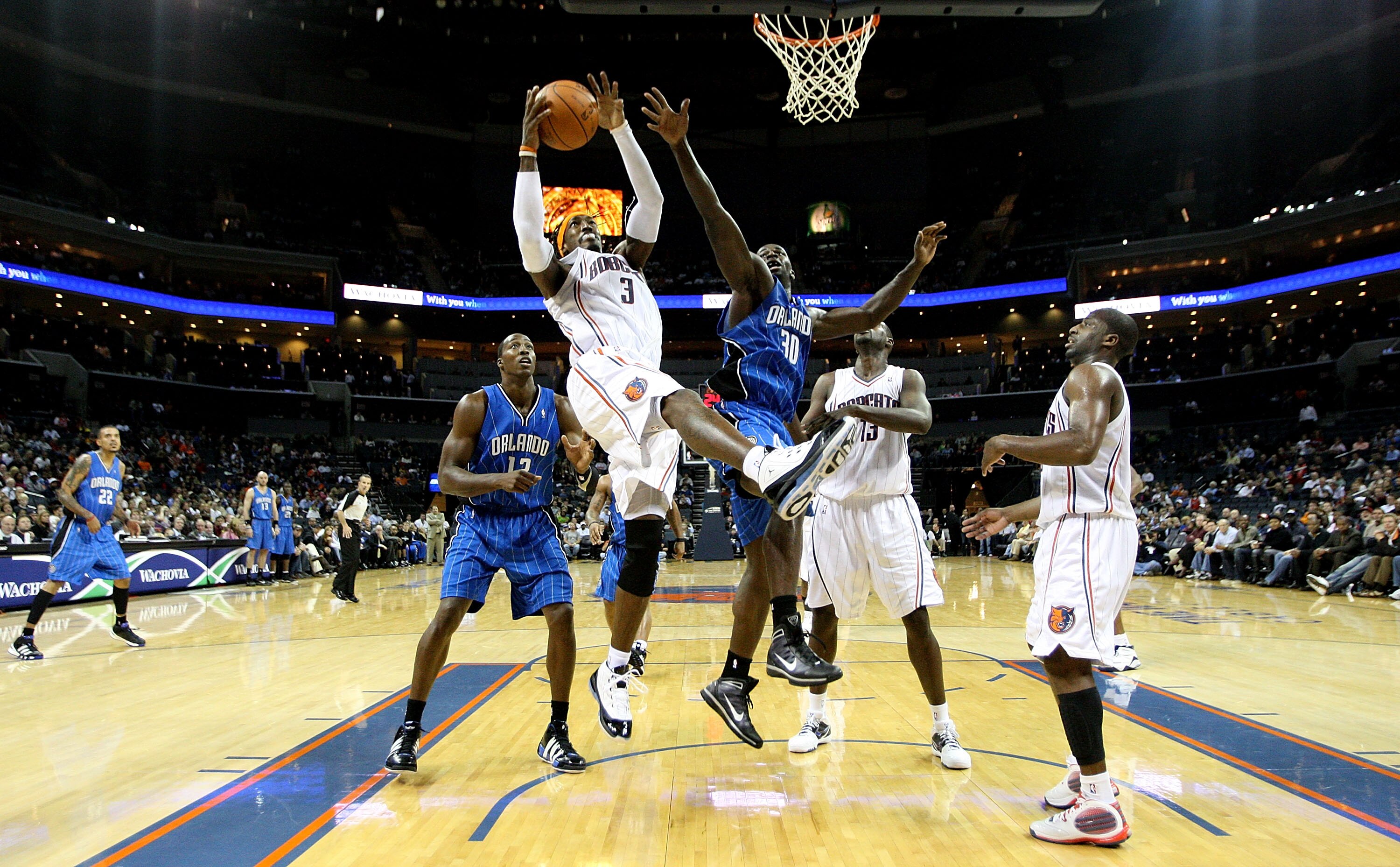 CHARLOTTE, NC - NOVEMBER 10:  Brandon Bass #30 of the Orlando Magic goes up for a rebound against Gerald Wallace #3 of the Charlotte Bobcats in NBA action at Time Warner Cable Arena on November 10, 2009 in Charlotte, North Carolina. NOTE TO USER: User exp