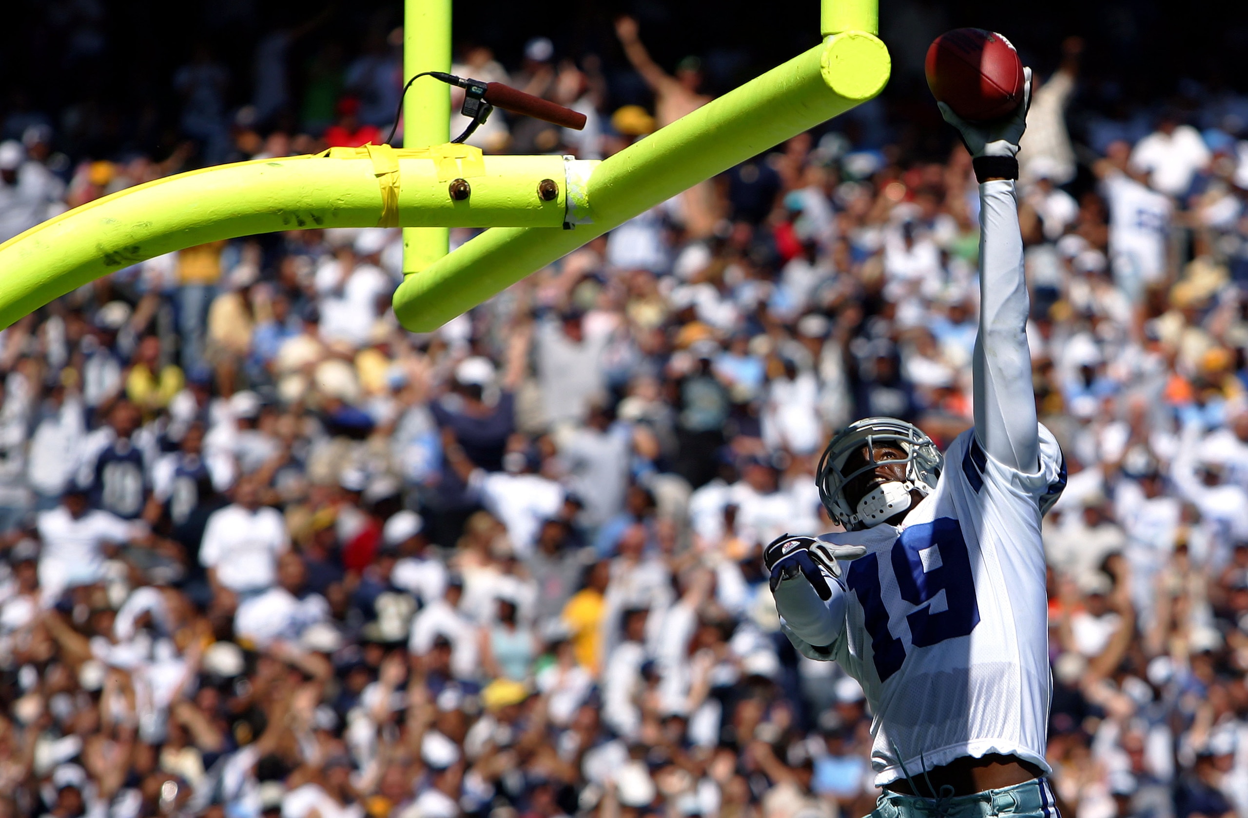 SAN DIEGO, CA -  SEPTEMBER 11:   Wide Receiver Keyshawn Johnson #19 of the Dallas Cowboys dunks the ball over the field goal post after his touchdown against  the San Diego Chargers during the first half of their NFL Game on September 11, 2005 at Qualcomm