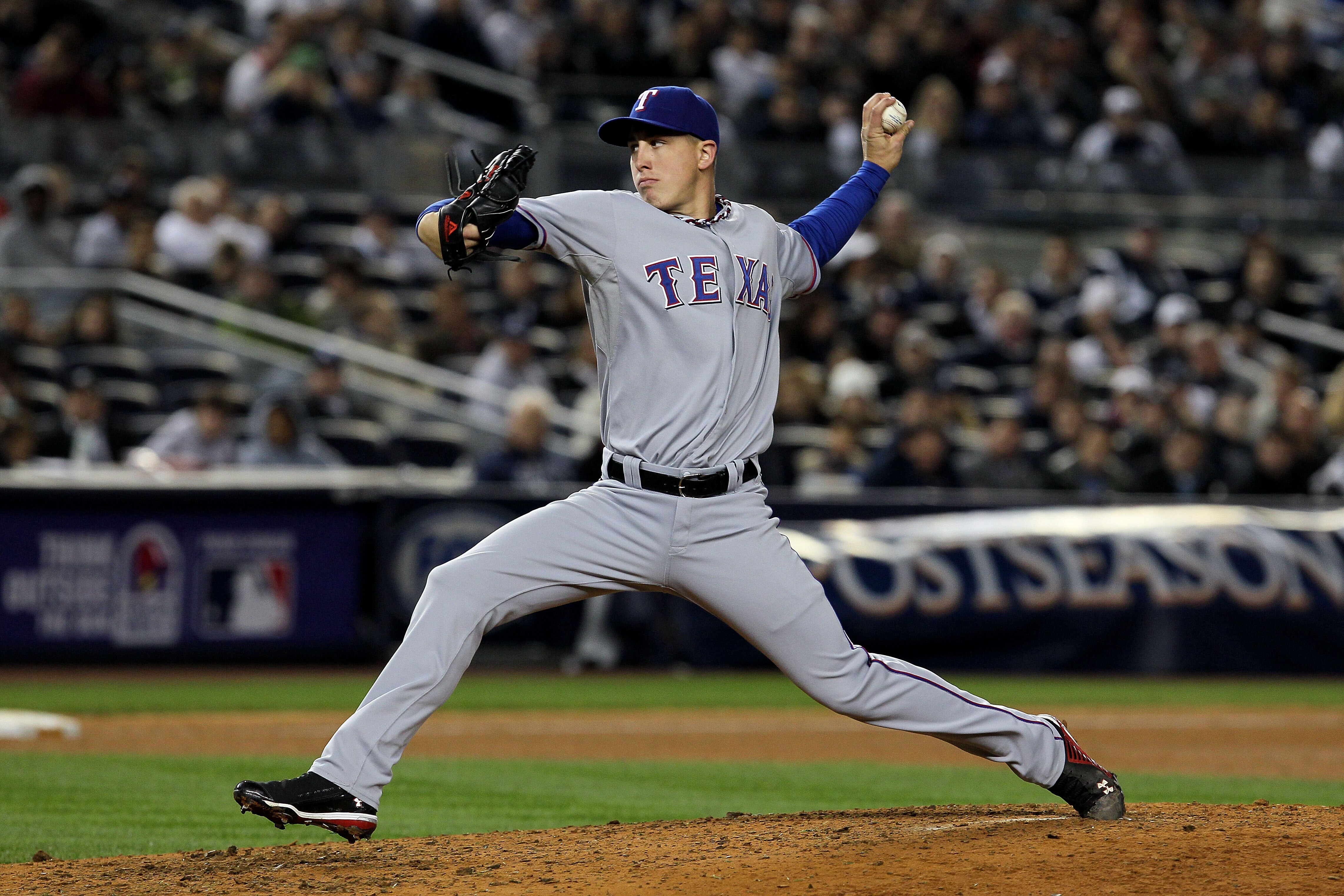 NEW YORK - OCTOBER 19:  Derek Holland #45 of the Texas Rangers pitches against the New York Yankees in Game Four of the ALCS during the 2010 MLB Playoffs at Yankee Stadium on October 19, 2010 in the Bronx borough of New York City.  (Photo by Jim McIsaac/G