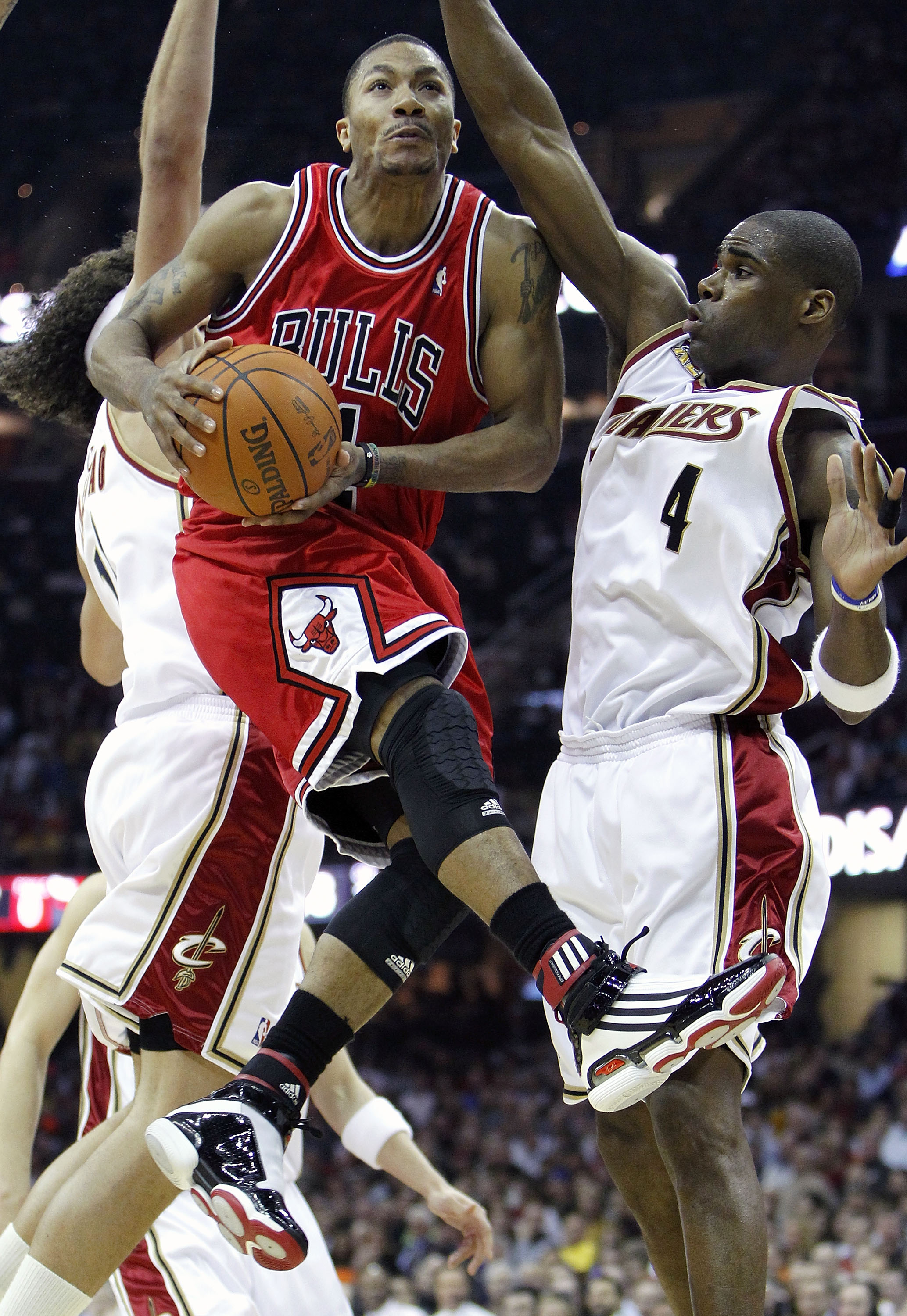 CLEVELAND - APRIL 27:  Derrick Rose #1 of the Chicago Bulls goes up for a shot against Antawn Jamison #4 and Anderson Varejao #17 of the Cleveland Cavaliers in Game Five of the Eastern Conference Quarterfinals during the 2010 NBA Playoffs at Quicken Loans