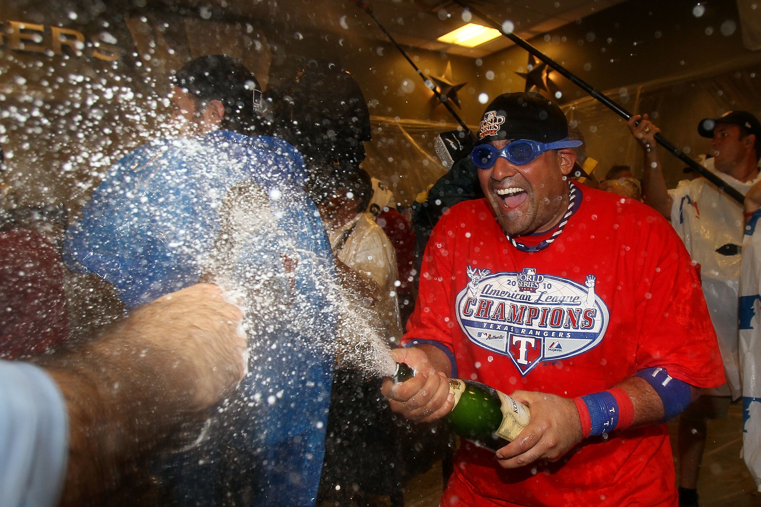 ARLINGTON, TX - OCTOBER 22:  Bengie Molina #11 of the Texas Rangers sprays champagne in the lockerroom after defeating the New York Yankees 6-1 in Game Six of the ALCS to advance to the World Series during the 2010 MLB Playoffs at Rangers Ballpark in Arli