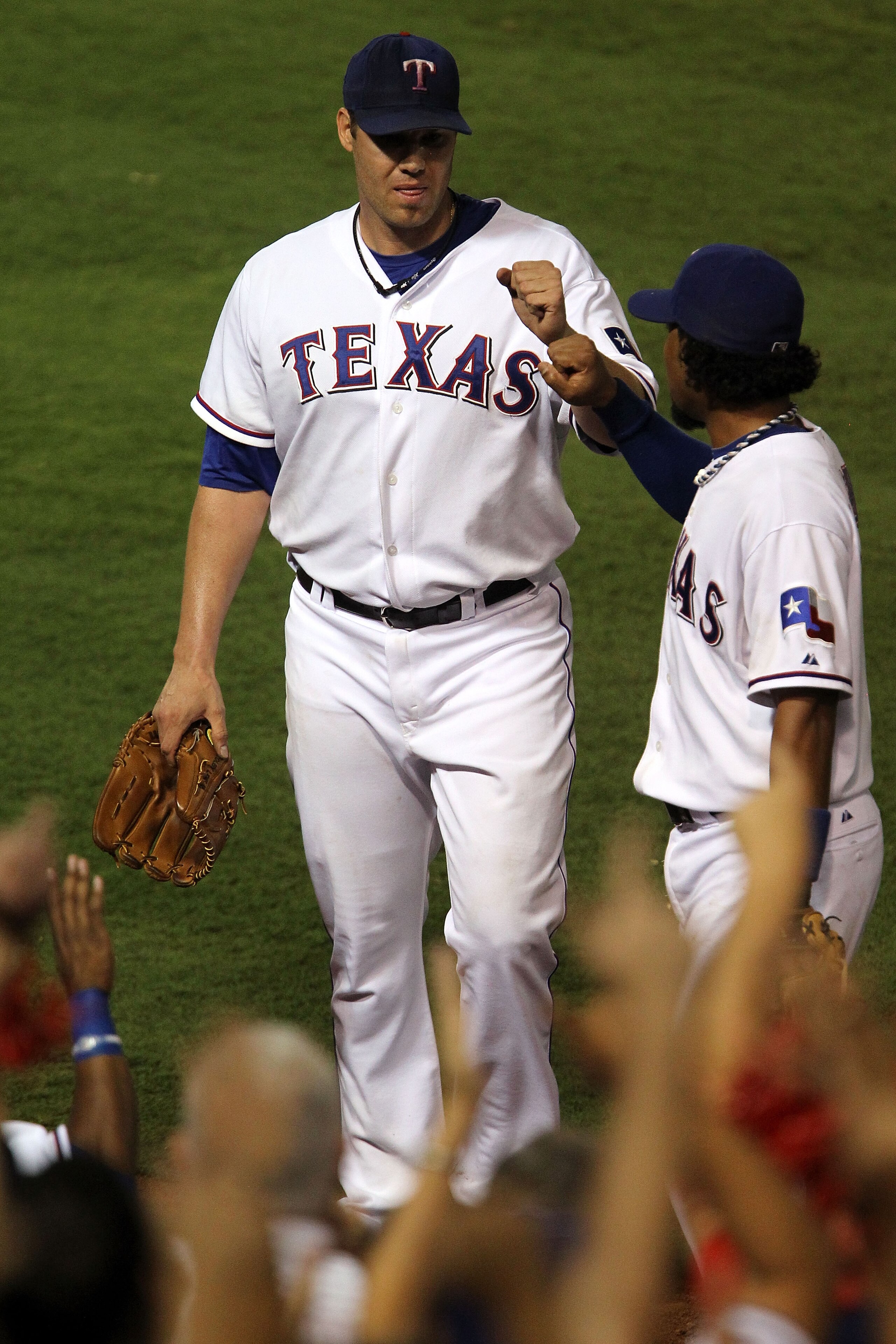 ARLINGTON, TX - OCTOBER 22:  Colby Lewis #48 of the Texas Rangers is congratulated by teammate Elvis Andrus #1 after pitching in the eighth inning of Game Six of the ALCS against the New York Yankees during the 2010 MLB Playoffs at Rangers Ballpark in Arl