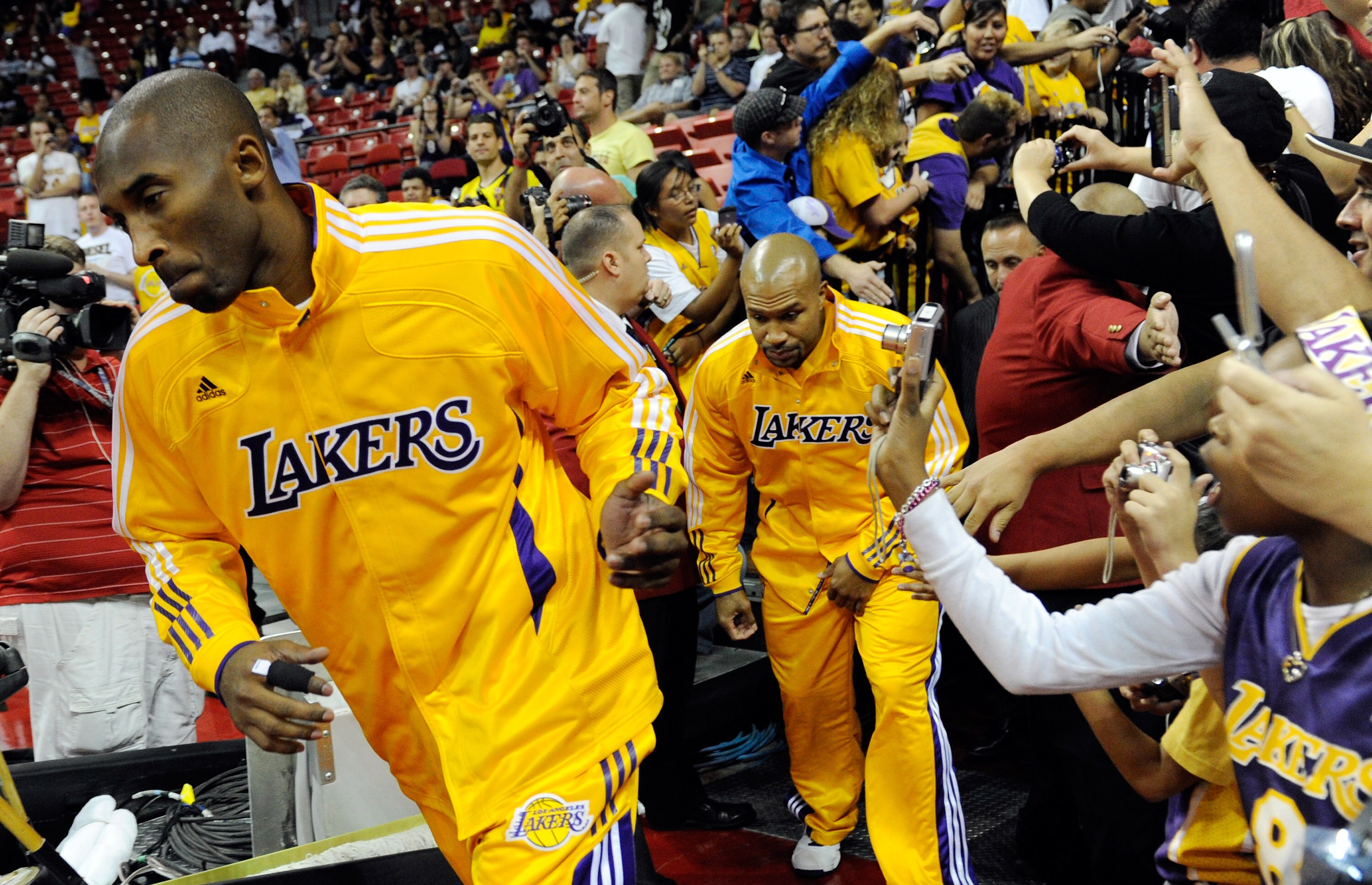 LAS VEGAS - OCTOBER 13:  Kobe Bryant #24 (L) and Derek Fisher #2 of the Los Angeles Lakers run onto the court before their preseason game against the Sacramento Kings at the Thomas & Mack Center October 13, 2010 in Las Vegas, Nevada. The Lakers won 98-95.