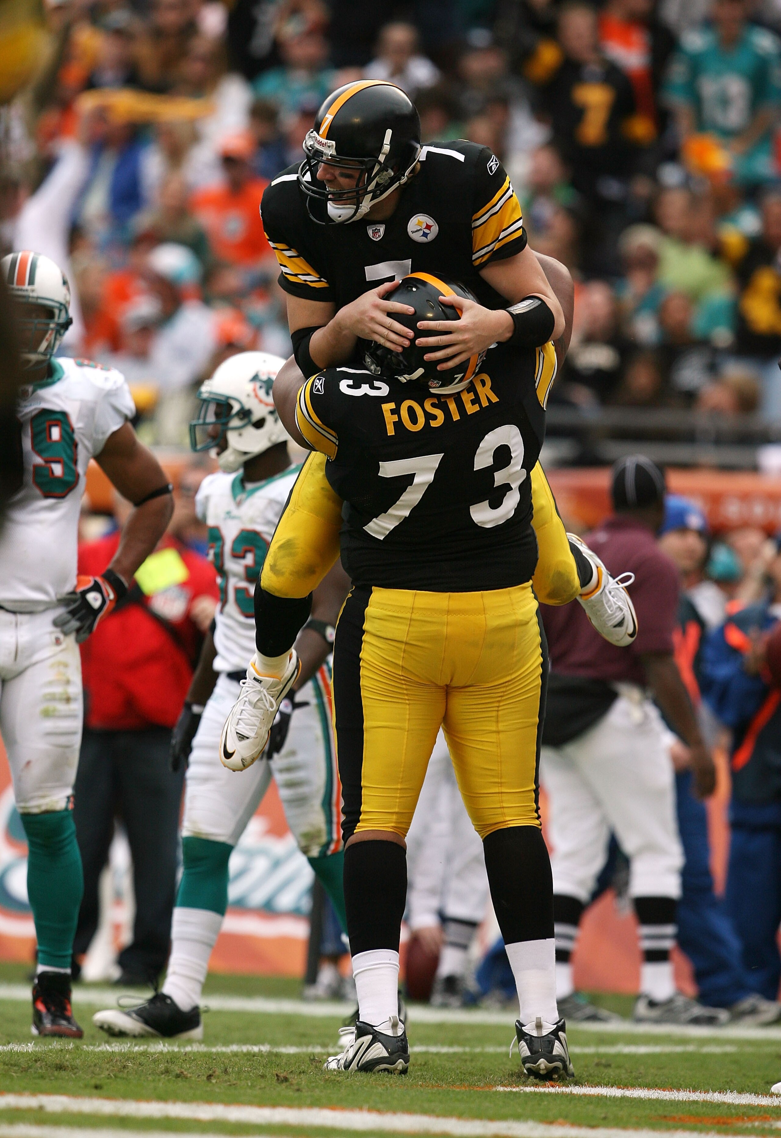 MIAMI - JANUARY 03:  Quarterback Ben Roethlisberger #7 of the Pittsburgh Steelers is lifted into the air by offensive linemen Ramon Foster #73 after Roethlisberger's touchdown pass to tight end Heath Miller #83 in the third quarter against the Miami Dolph