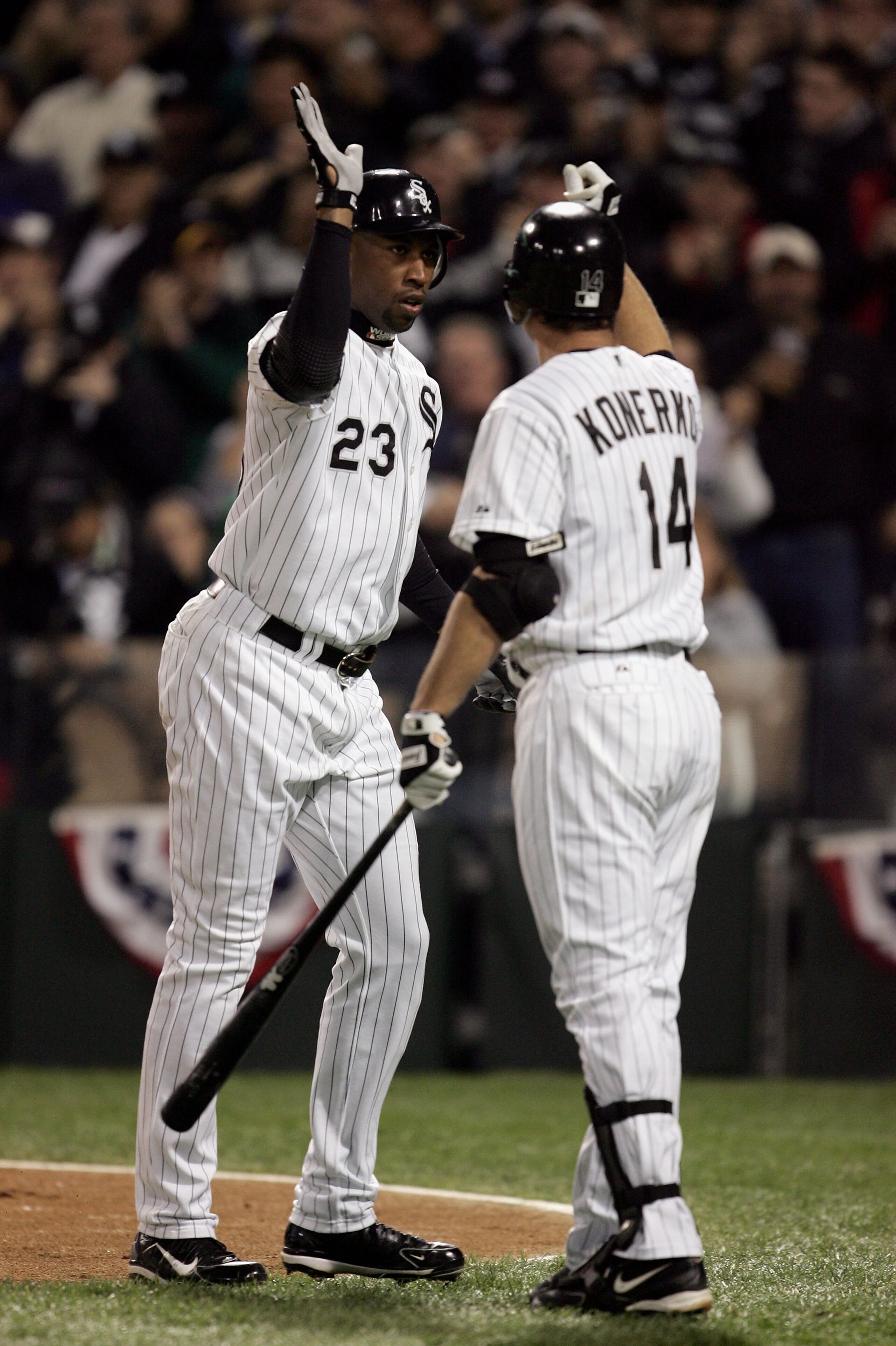 CHICAGO - OCTOBER 22:  Jermaine Dye #23 of the Chicago White Sox is congratulated by teammate Paul Konerko #14 after hitting a solo homerun against the Houston Astros in the first inning of Game One of the 2005 Major League Baseball World Series against t