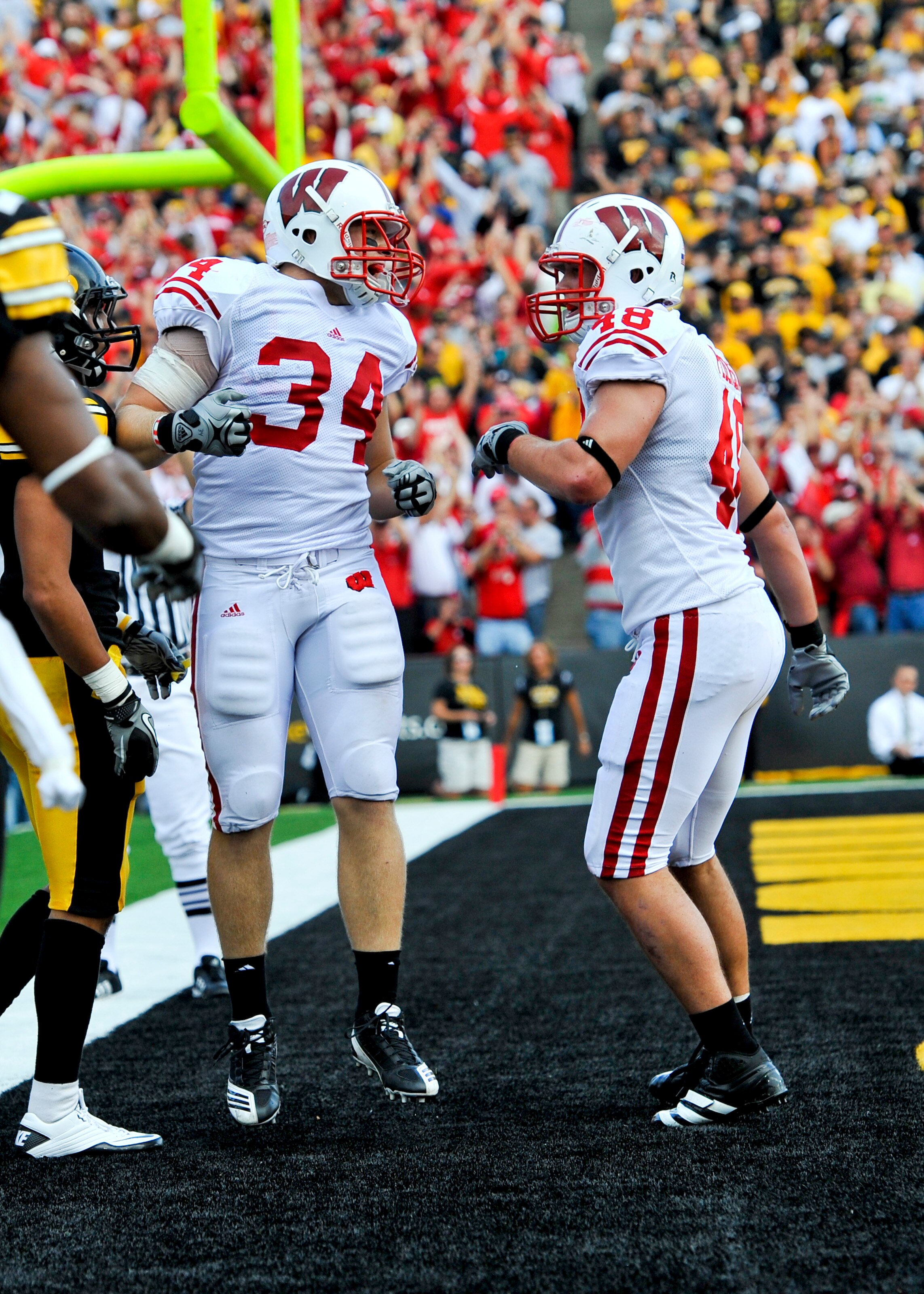 IOWA CITY, IA - OCTOBER 23: Running back Bradie Ewing #34 of the Wisconsin Badgers celebrates with teammate tight end Jacob Pedersen #48 after scoring a touchdown during the second half of play against the University of Iowa Hawkeyes at Kinnick Stadium on IOWA CITY, IA - OCTOBER 23: Running back Bradie Ewing #34 of the Wisconsin Badgers celebrates with teammate tight end Jacob Pedersen #48 after scoring a touchdown during the second half of play against the University of Iowa Hawkeyes at Kinnick Stadium on