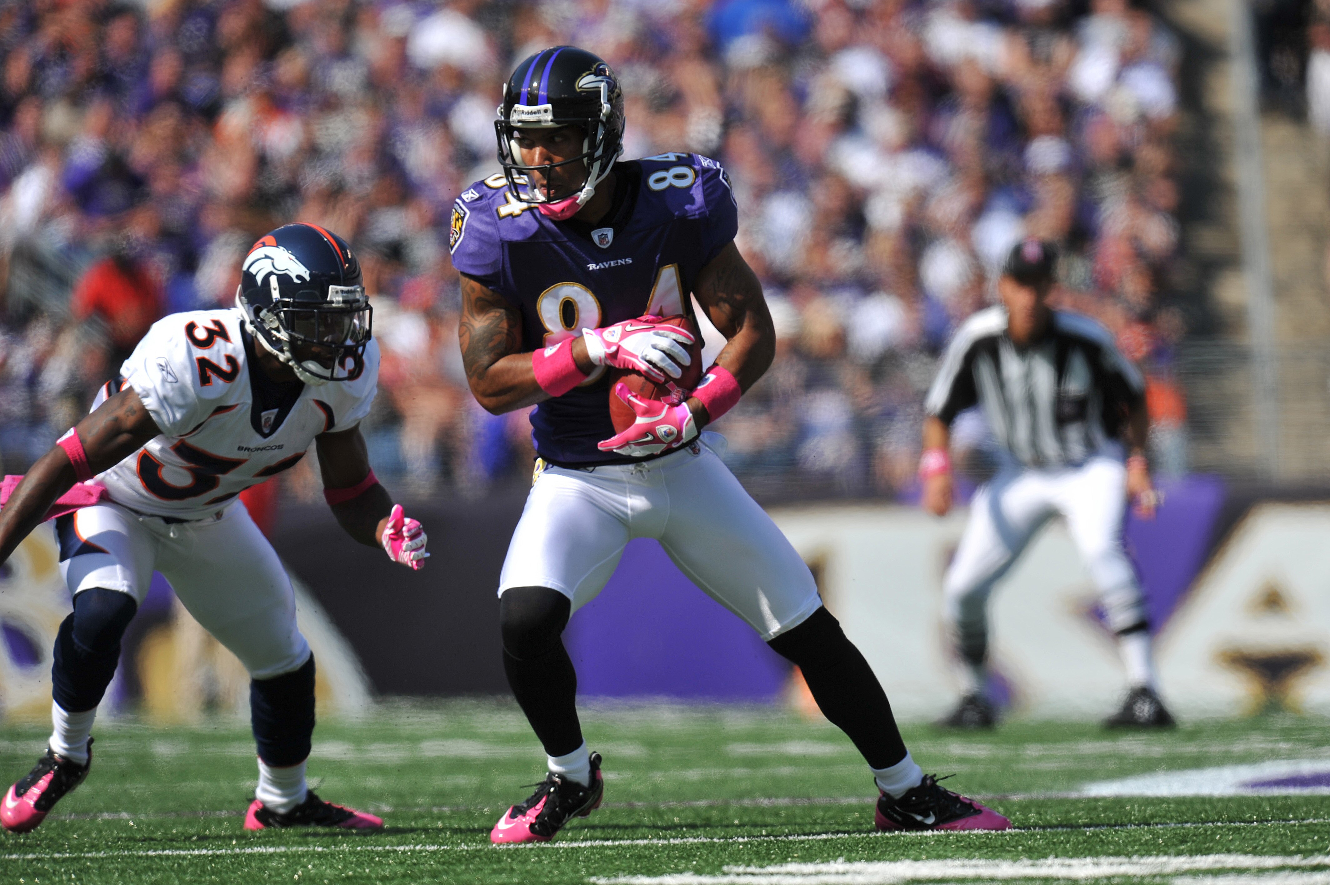 BALTIMORE, MD - OCTOBER 10: T.J. Houshmandzadeh #84 of the Baltimore Ravens makes a catch against the Denver Broncos at M&T Bank Stadium on October 10, 2010 in Baltimore, Maryland. Players wore pink in recognition of Breast Cancer Awareness Month. The Rav