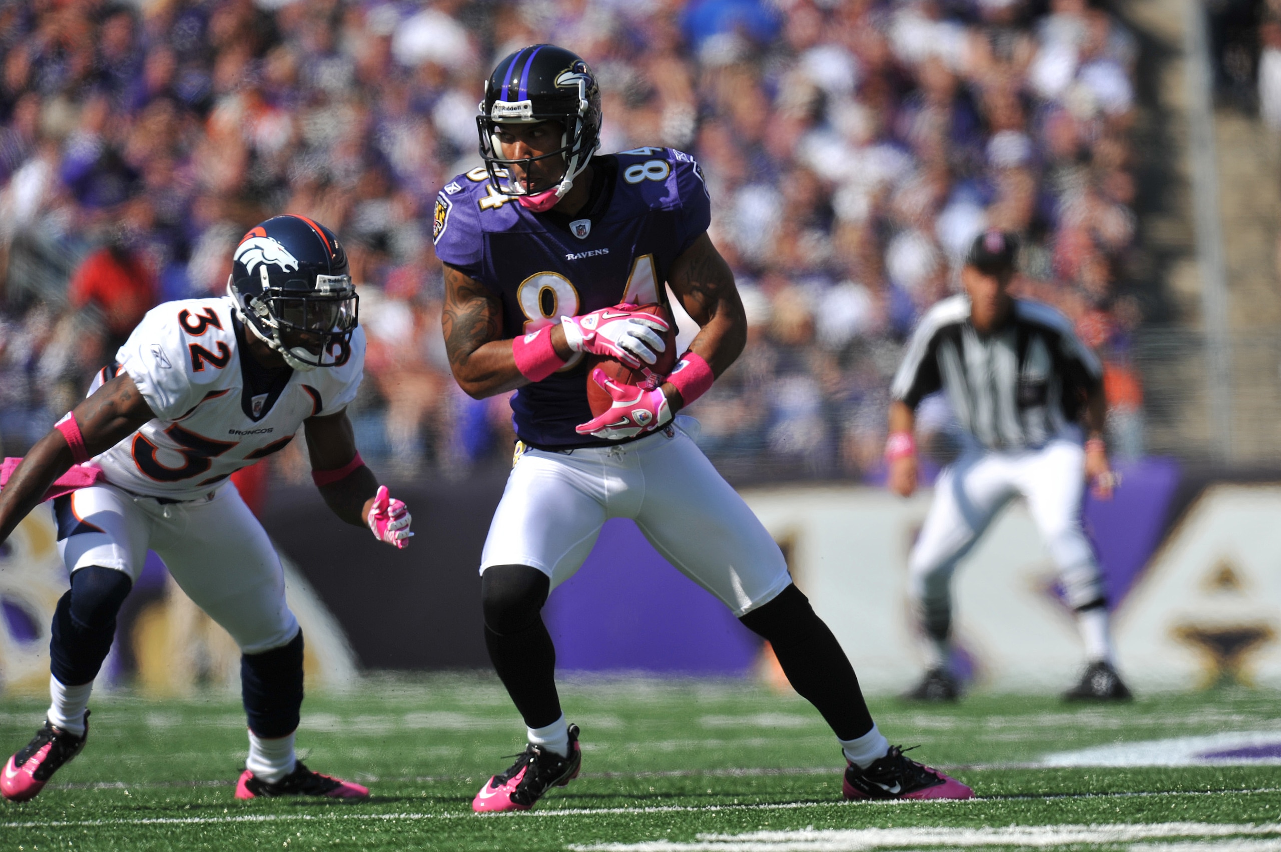 BALTIMORE, MD - OCTOBER 10: T.J. Houshmandzadeh #84 of the Baltimore Ravens makes a catch against the Denver Broncos at M&T Bank Stadium on October 10, 2010 in Baltimore, Maryland. Players wore pink in recognition of Breast Cancer Awareness Month. The Rav
