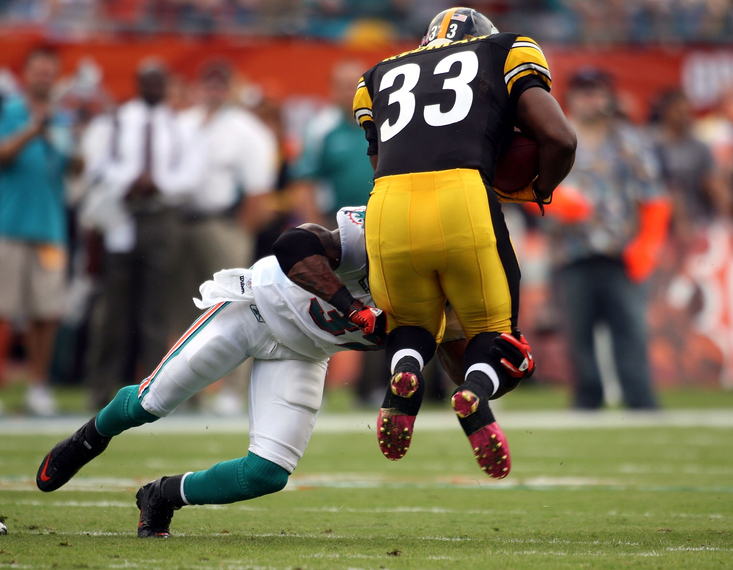 MIAMI - OCTOBER 24:  Running back Isaac Redman #33 is tackled by cornerback Jason Allen #32 of the Miami Dolphins at Sun Life Stadium on October 24, 2010 in Miami, Florida.  (Photo by Marc Serota/Getty Images)