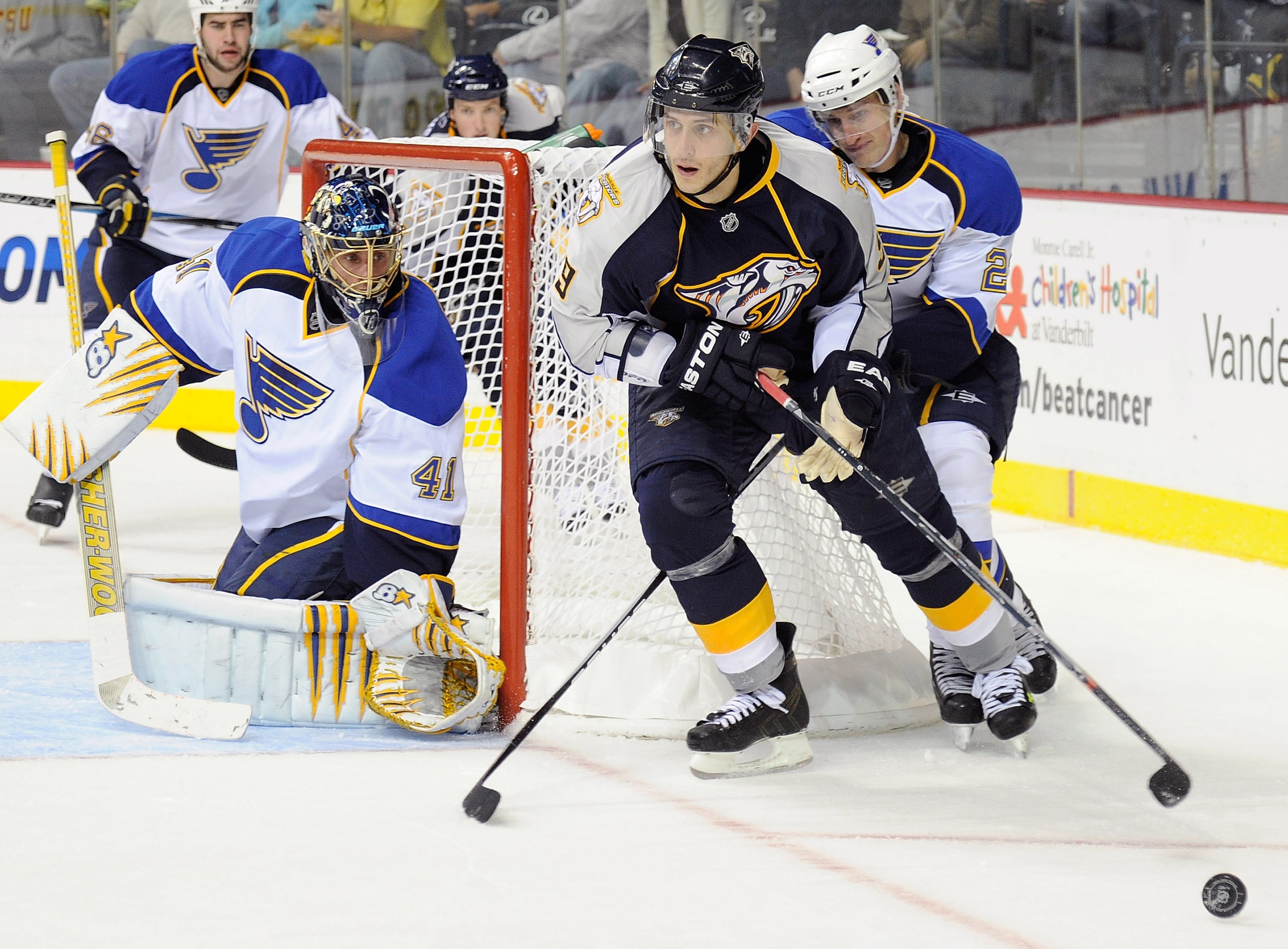NASHVILLE, TN - OCTOBER 14:  Center Marcel Goc #9 of the Nashville Predators carries the puck past center Brad Boyes #22 and goalie Jaroslav Halak #41 of the St. Louis Blues on October 14, 2010 in Nashville, Tennessee.  (Photo by Frederick Breedon/Getty I