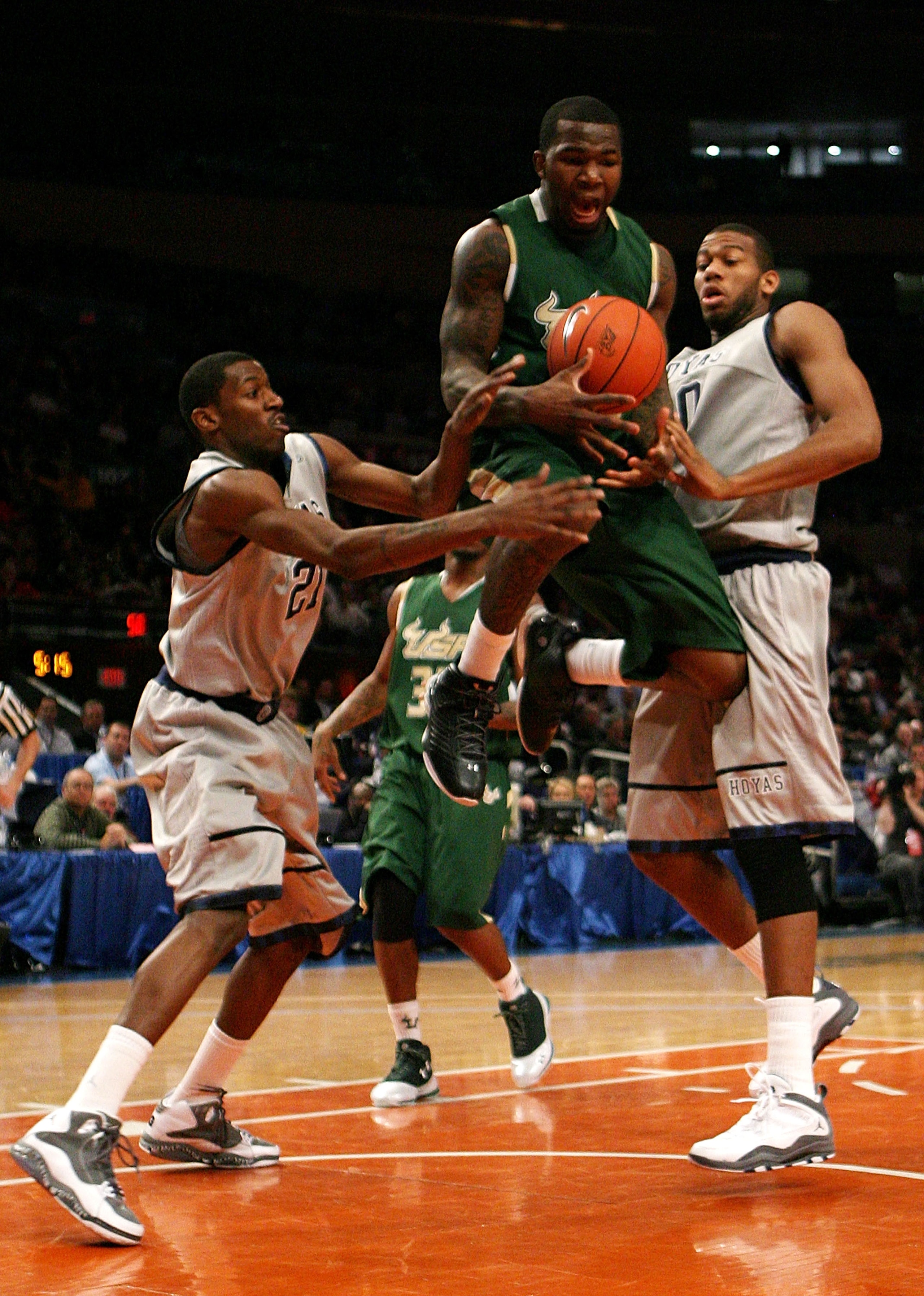 NEW YORK - MARCH 10:  Dominique Jones #20 of the USF Bulls loses control of the ball against Jason Clark #21 and Greg Monroe #10 of the Georgetown Hoyas during the second round of 2010 NCAA Big East Tournament at Madison Square Garden on March 10, 2010 in