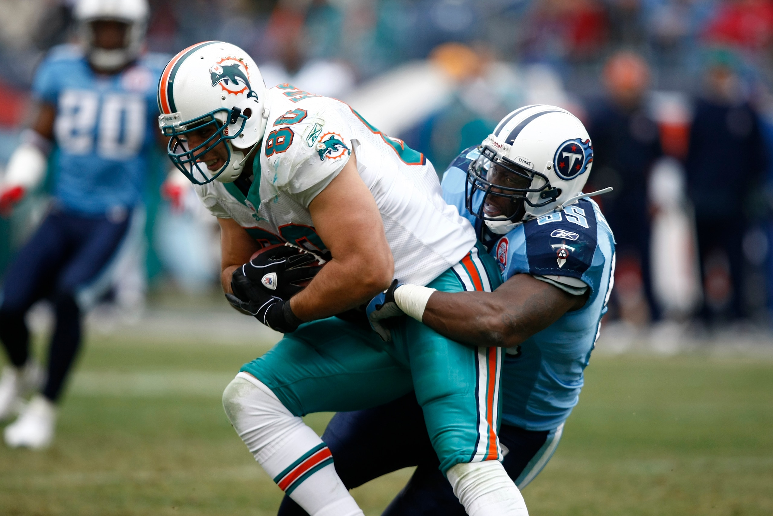 NASHVILLE, TN - DECEMBER 20: Stephen Tulloch #55 of the Tennessee Titans tackles Anthony Fasano #80 of the Miami Dolphins at LP Field on December 20, 2009 in Nashville, Tennessee. The Titans defeated the Dolphins 27-24 in overtime. (Photo by Joe Robbins/G