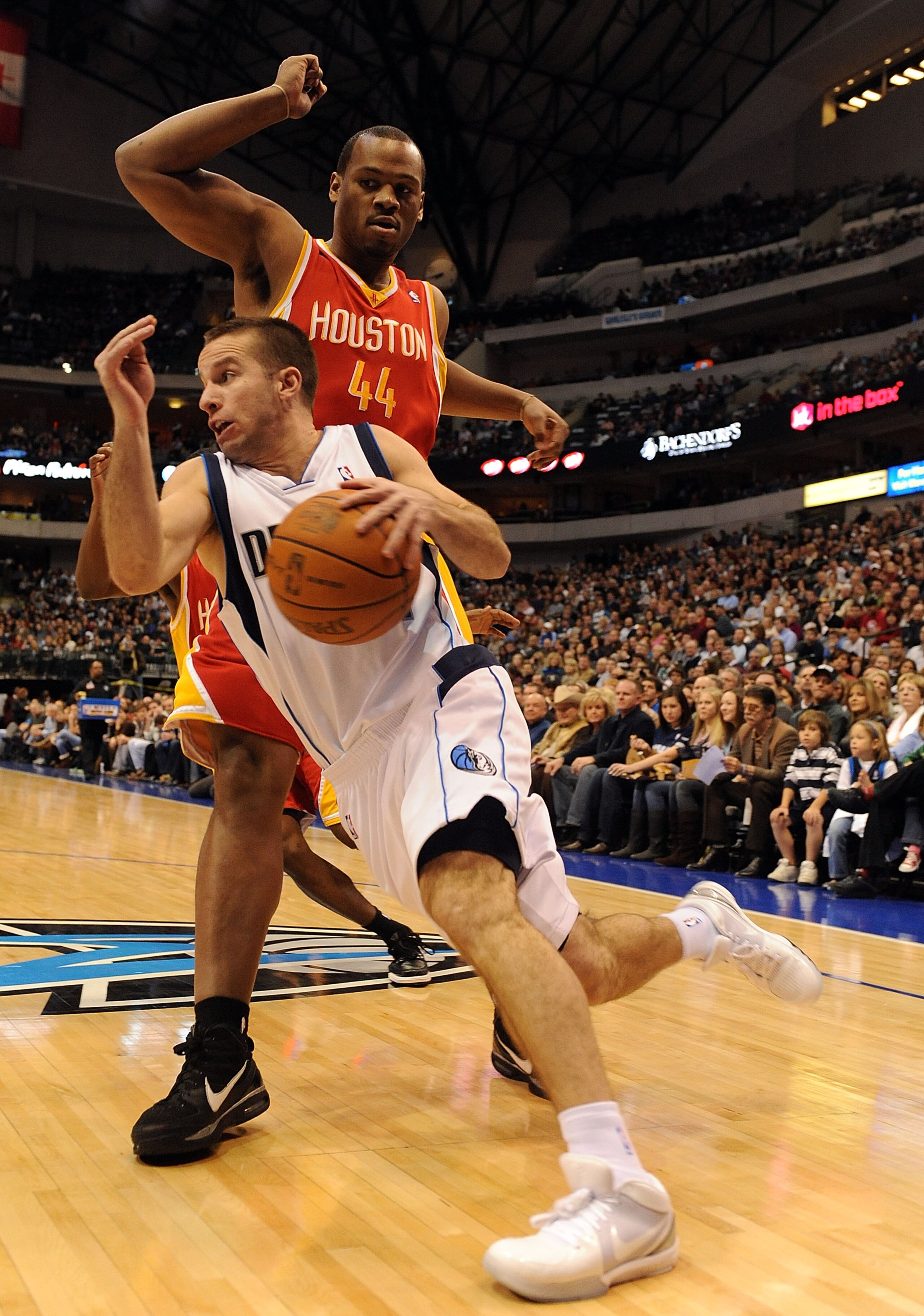DALLAS - DECEMBER 18:  Guard Jose Juan Barea #11 of the Dallas Mavericks dribbles the ball against Chuck Hayes #44 of the Houston Rockets on December 18, 2009 at American Airlines Center in Dallas, Texas.  NOTE TO USER: User expressly acknowledges and agr