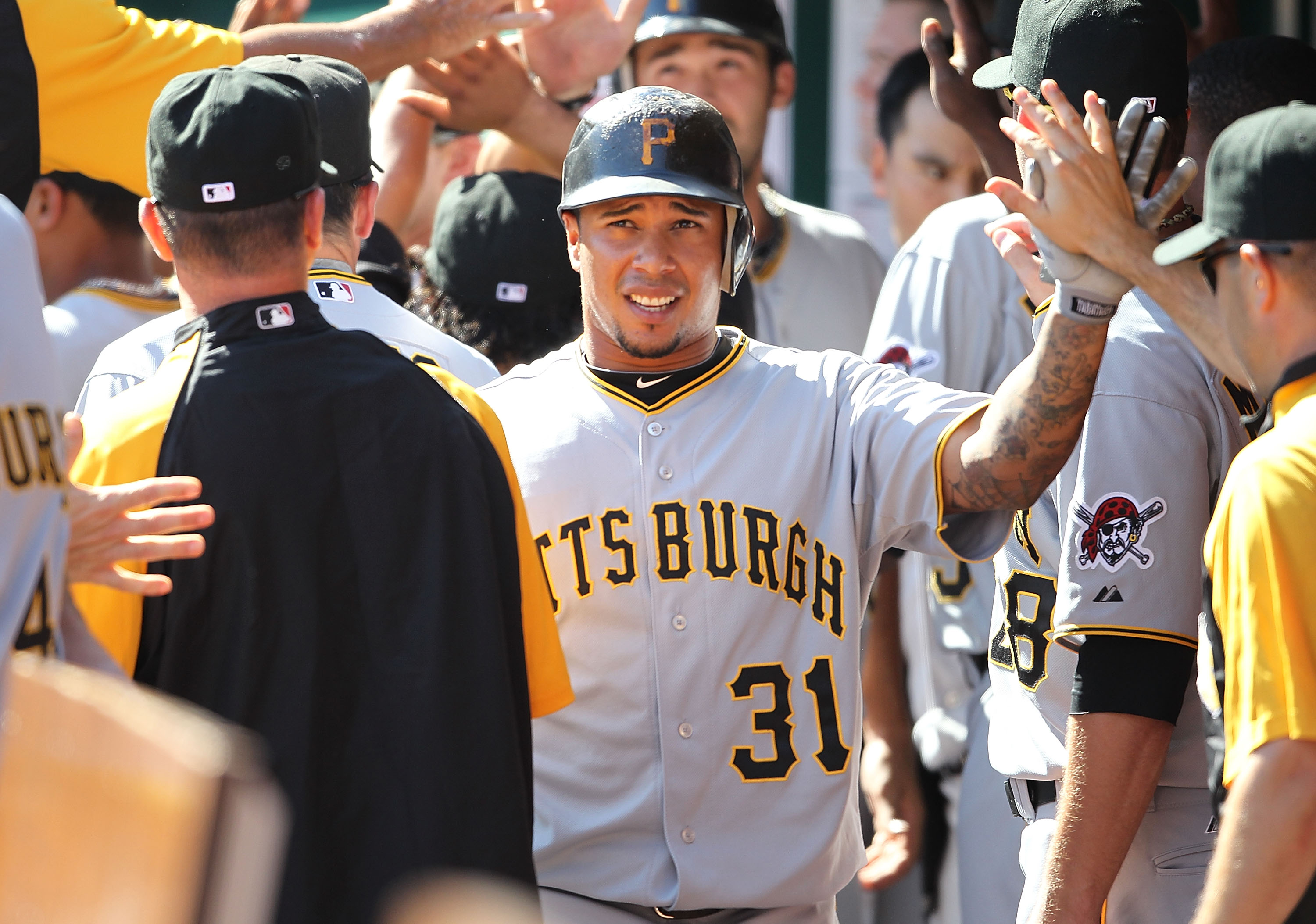 CINCINNATI - SEPTEMBER 12:  Jose Tabata #31 of the Pittsburgh Pirates is congratulated by teammates after scoring one of the three ninth inning runs during the game against the Cincinnati Reds at Great American Ballpark on September 12, 2010 in Cincinnati