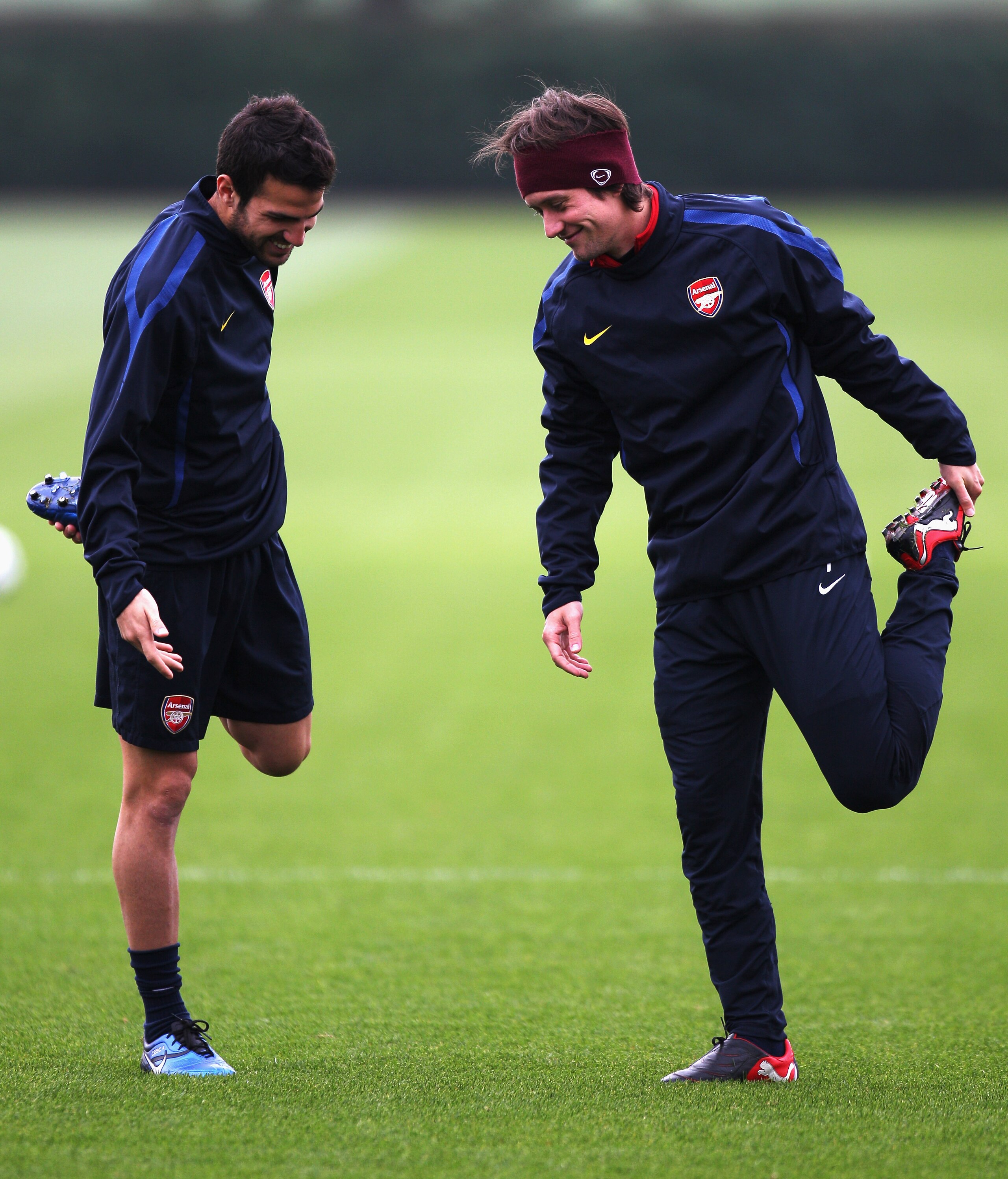 ST ALBANS, ENGLAND - OCTOBER 18:  Cesc Fabregas  (L) and Tomas Rosicky warm up during a training session ahead of the UEFA Champions League game against Shakhtar Donetsk at the club's complex at London Colney on October 18, 2010 in St Albans, England.  (P