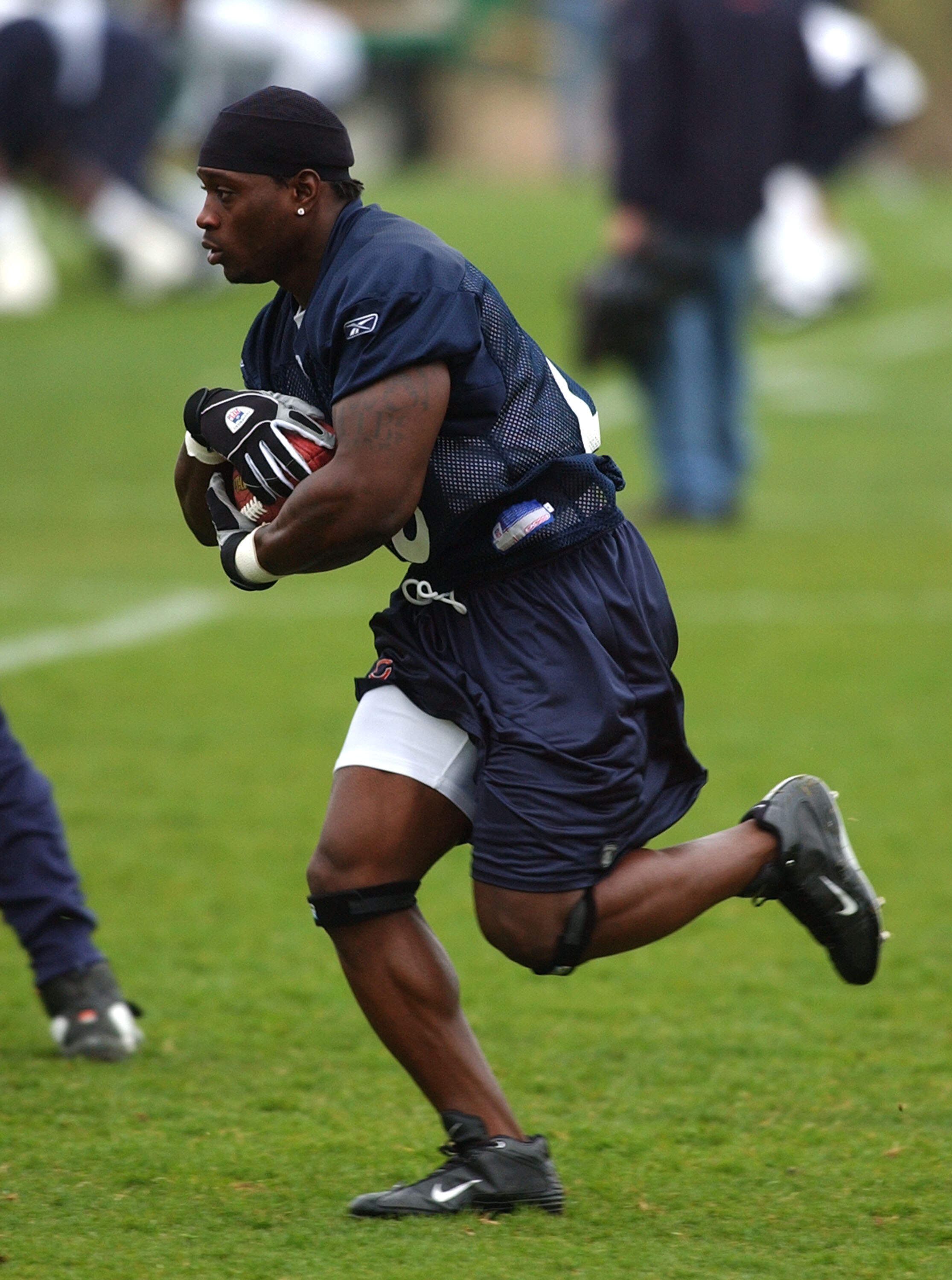 LAKE FOREST, IL - APRIL 30: Running back Thomas Jones #20 of the Chicago Bears, a free agent signed by the Bears from Tampa Bay, runs with the ball during the Bears mini-camp workout on April 30, 2004 at Halas Hall in Lake Forest, Illinois. (Photo by Jona