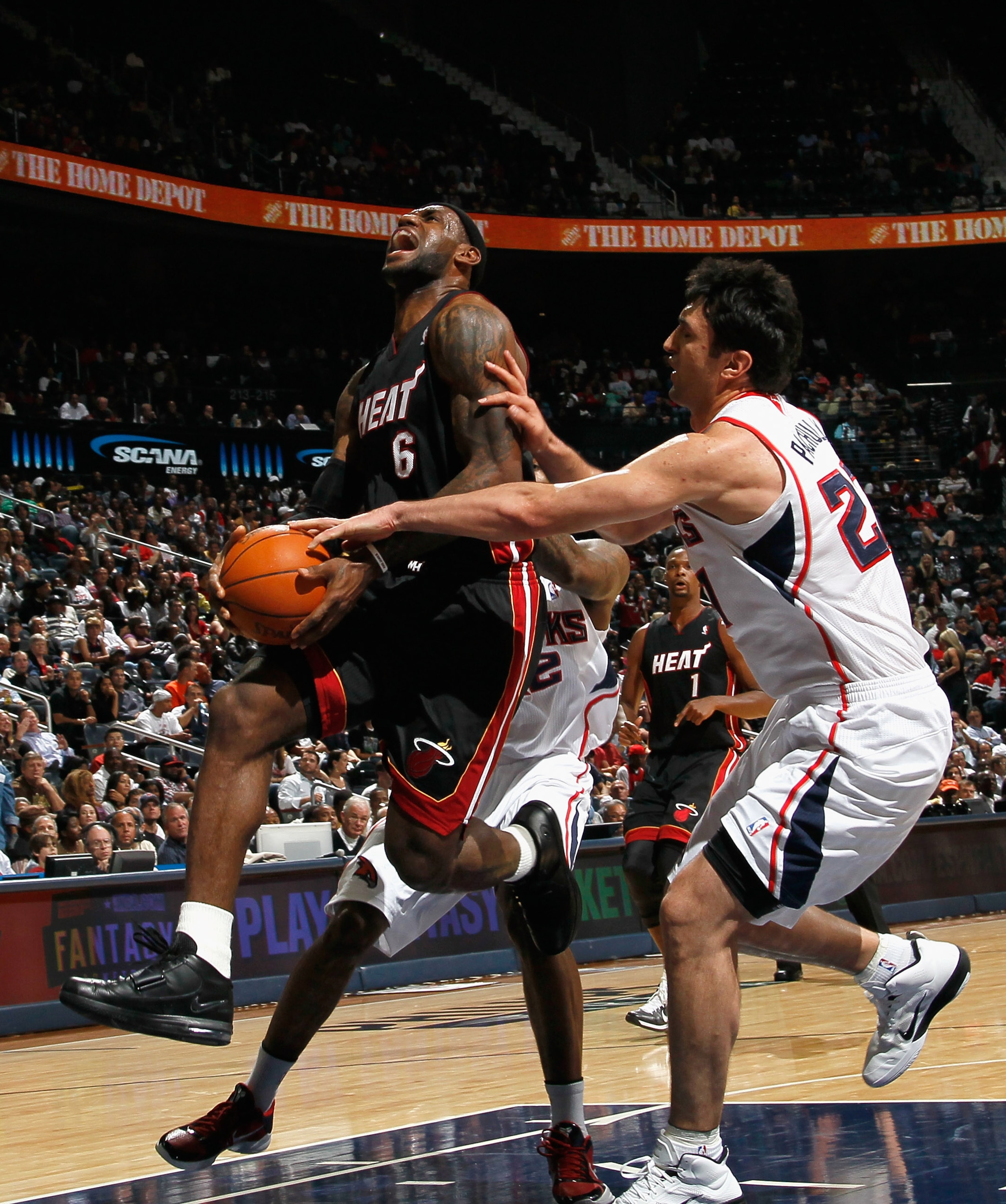 ATLANTA - OCTOBER 21:  LeBron James #6 of the Miami Heat is fouled by Zaza Pachulia #27 of the Atlanta Hawks at Philips Arena on October 21, 2010 in Atlanta, Georgia.  (Photo by Kevin C. Cox/Getty Images)
